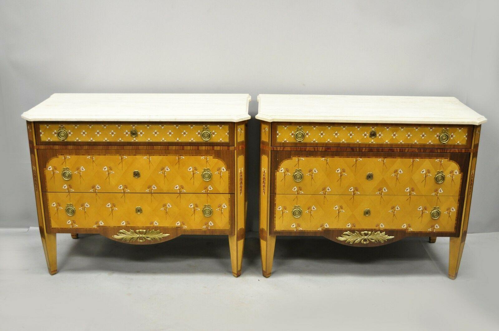 Pair of floral painted travertine marble-top commode chest dresser by E.J. Victor. Items feature shaped and bevelled travertine stone tops, floral painted details to fronts and sides, ornate brass hardware, beautiful wood grain, original label to