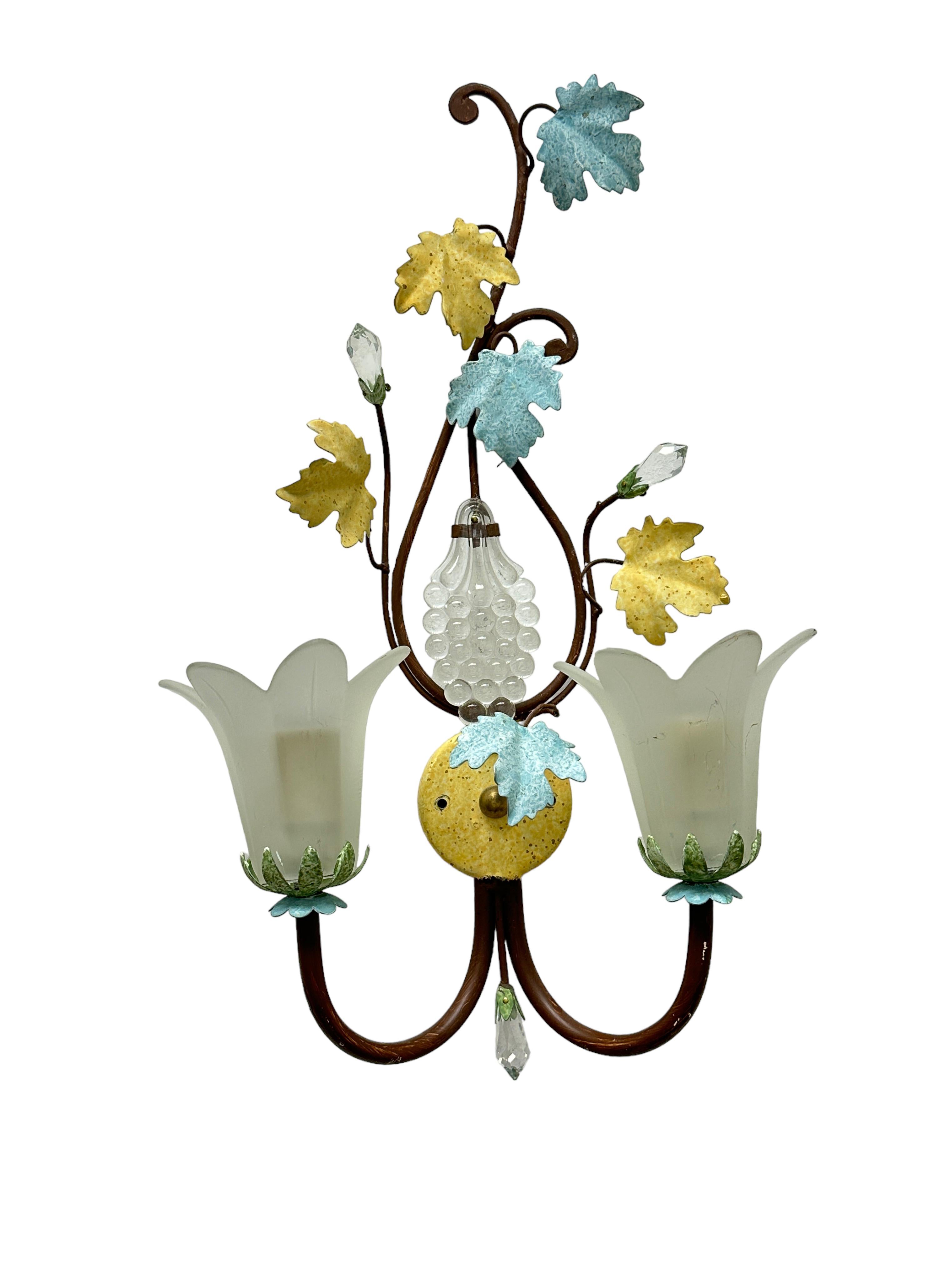 A pair iron floral sconces with crystal flowers and leaves. Each fixture requires two European E14 candelabra bulbs, each bulb up to 40 watts. The wall light has a beautiful patina and gives each room an eclectic statement. Made of metal and crystal