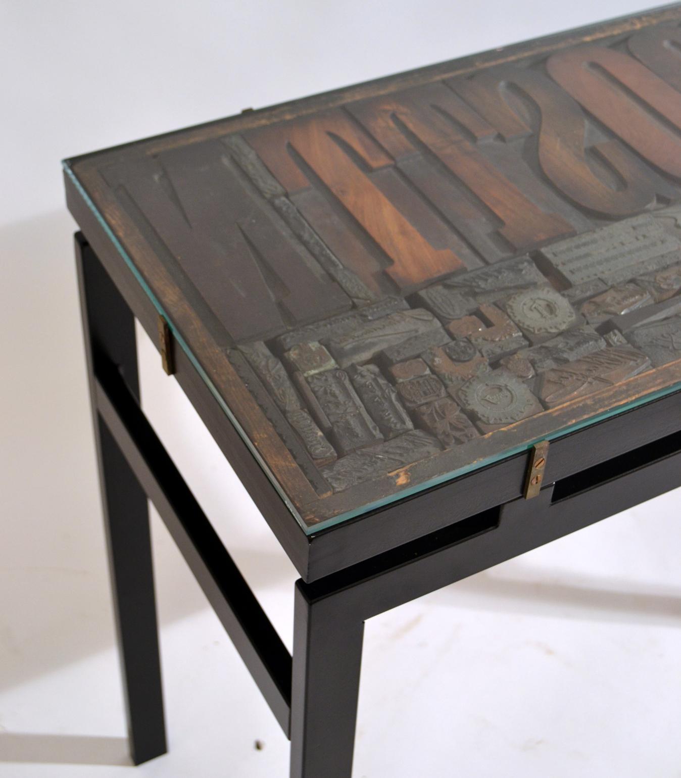 British Pair of Consoles with Wood Relief Top and Glass on Black Metal Frame For Sale
