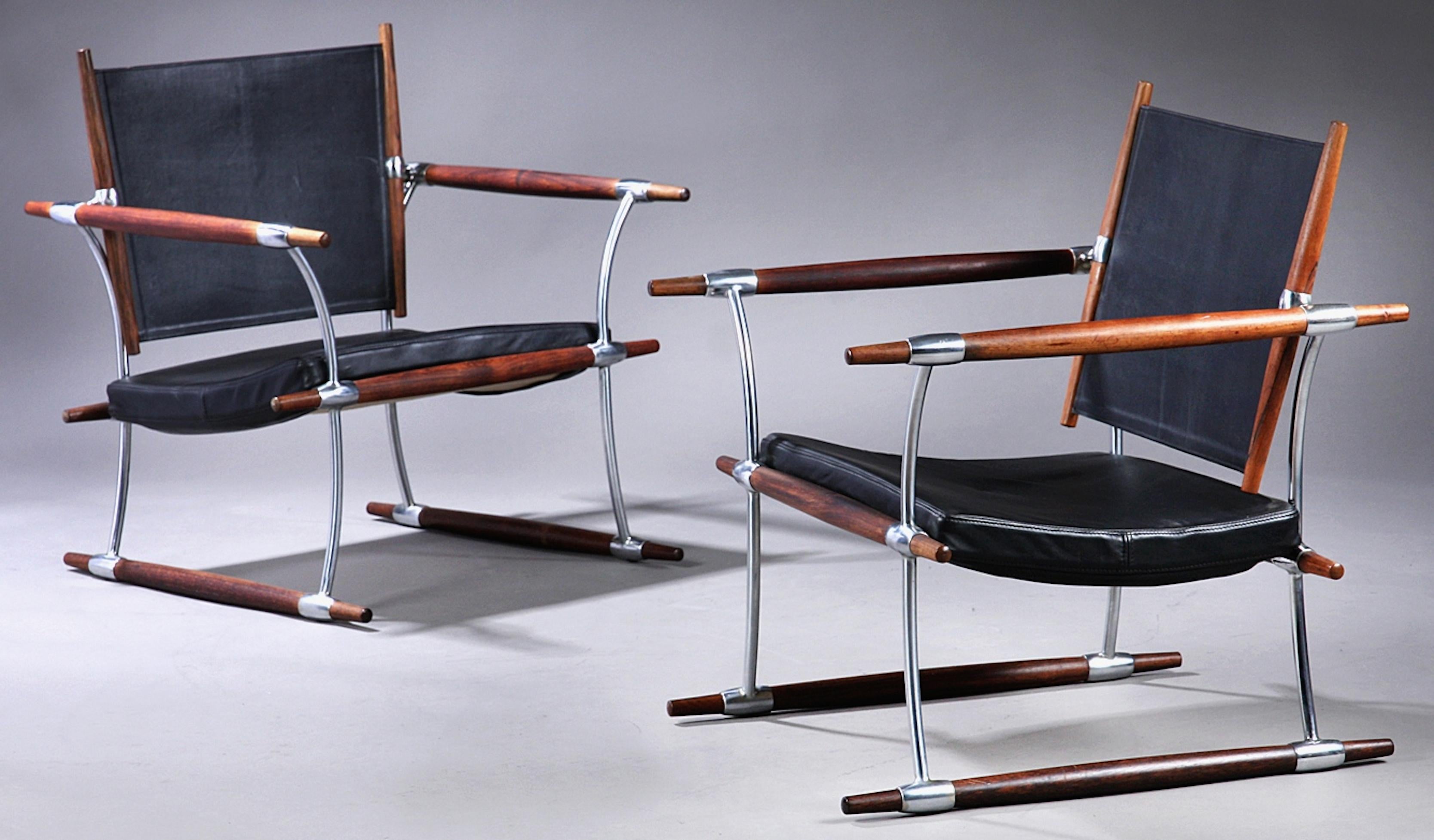 A pair of Jens Quistgaard chairs. Frame in solid Brazilian rosewood and chromed steel. Seat and back upholstered in black leather. Designed in 1966 and produced and stamped by Nissen in the 1960s.