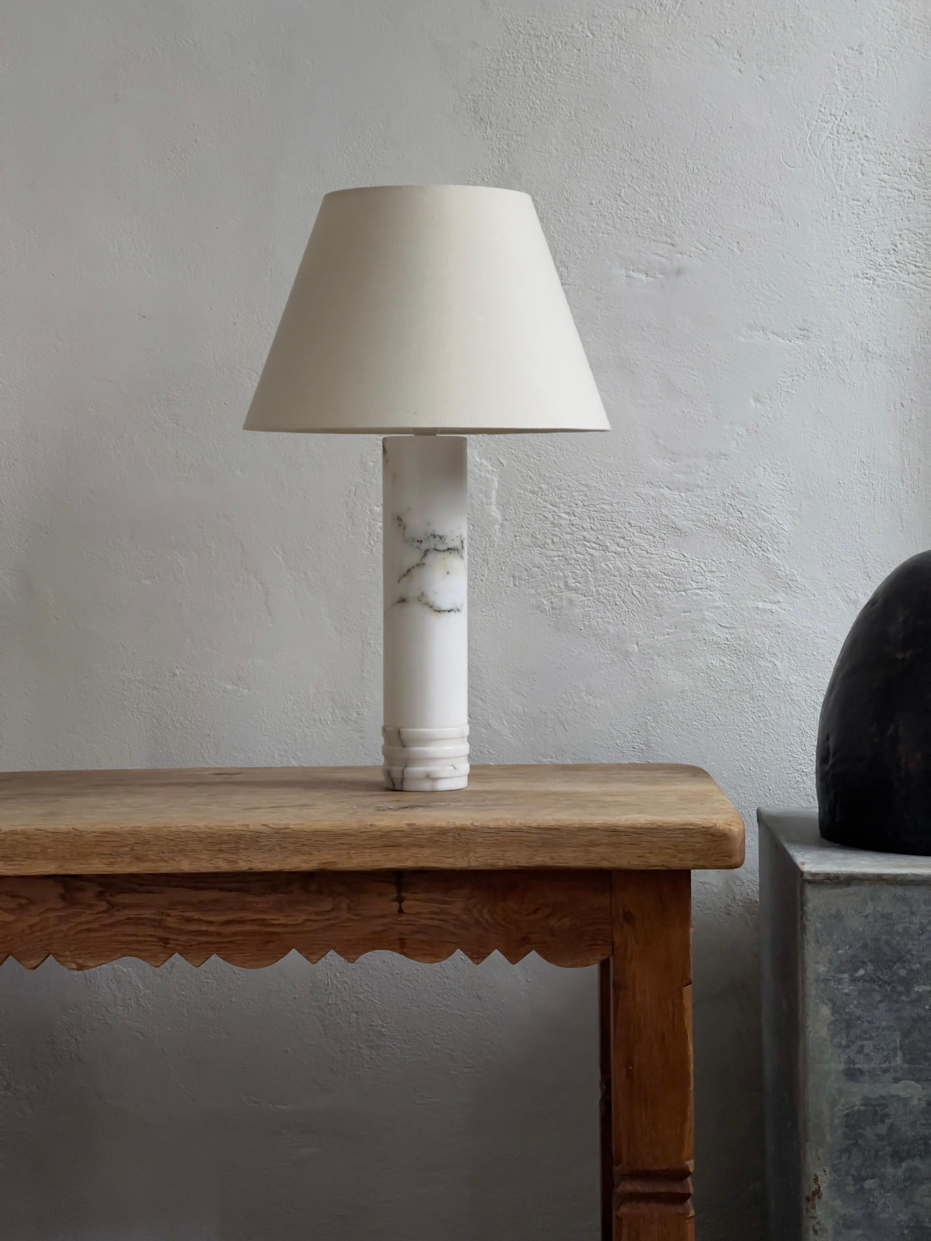 Pair of 1960s Swedish modern table lamps in solid marble and in very good condition. Manufactured by Bergboms in Sweden. Model B-10. A Single lamp also available please see listing. 
Dimension: (ex shade): diameter: 9, height: 43 cm.