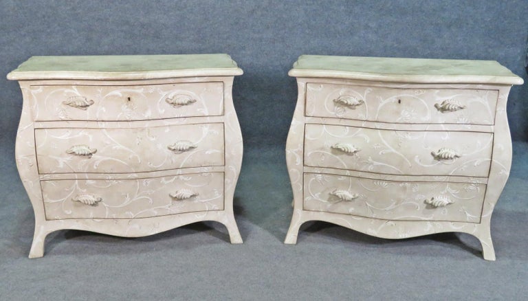 This is a gorgeous pair of painted floral commodes designed in the Gustavian style. The pair is in good condition with minor signs of age and use. The commodes measure 33 tall x 37 wide x 19.5 inches deep and date to the 1990s era.