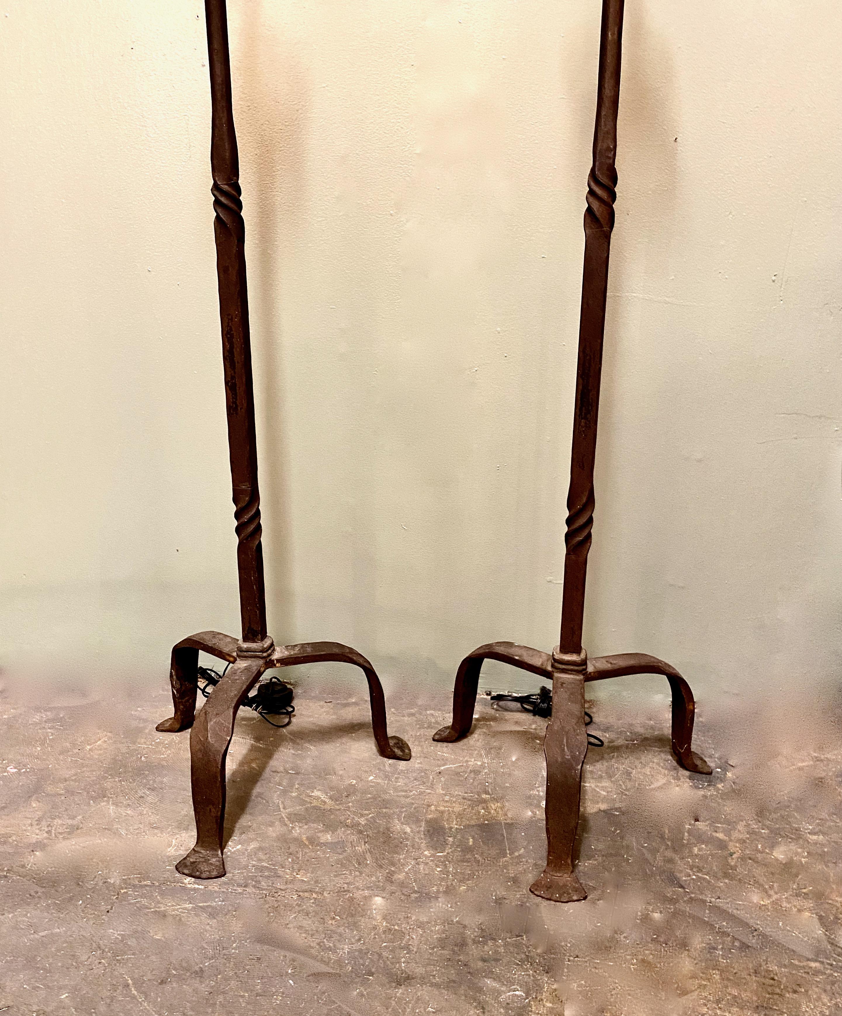 This is a great pair of forged iron floor lamps inspired by Giacometti. These lamps are very substantial and present a great hand forged surface that has acquired just the right amount of patina. The lamps have been rewired with new sockets with an