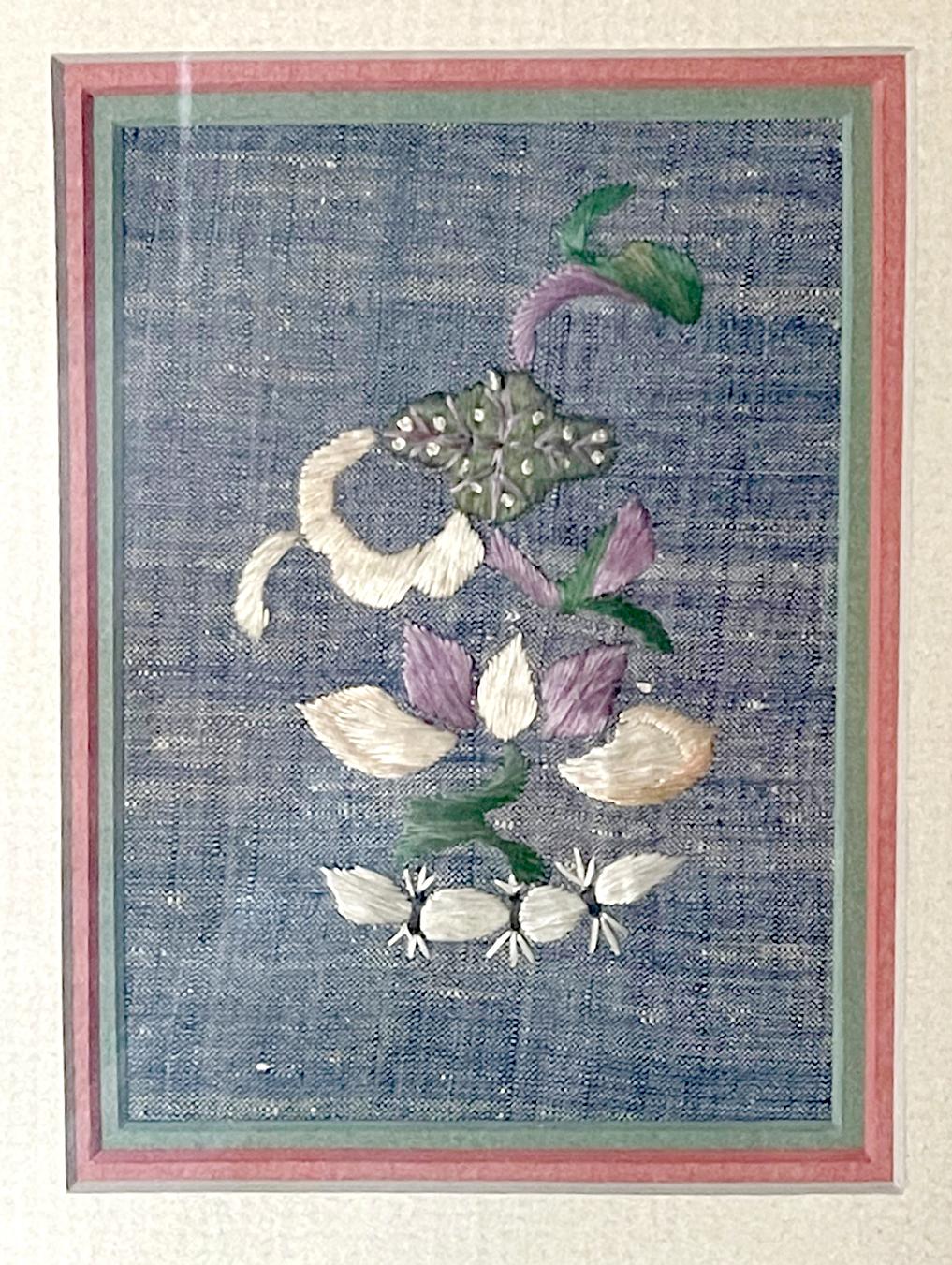 A pair of two antique textile fragments from China, circa 19th century Qing dynasty, professionally displayed in matching giltwood frame. On a light indigo blue linen background, one-piece depicts a flower branch, the other a cluster of peaches.