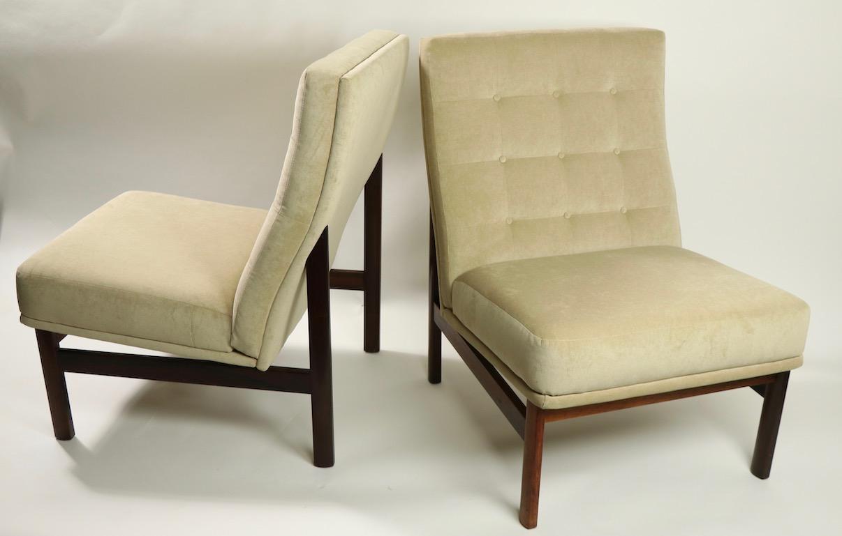 Wonderful pair of armless low lounge chairs marked France and Son design attributed to Ole Gjerlov Knudsen and Tobin Lind. The chairs have exposed architectural rosewood frames, and newly reupholstered (beige velvet) continuous seats and backs.