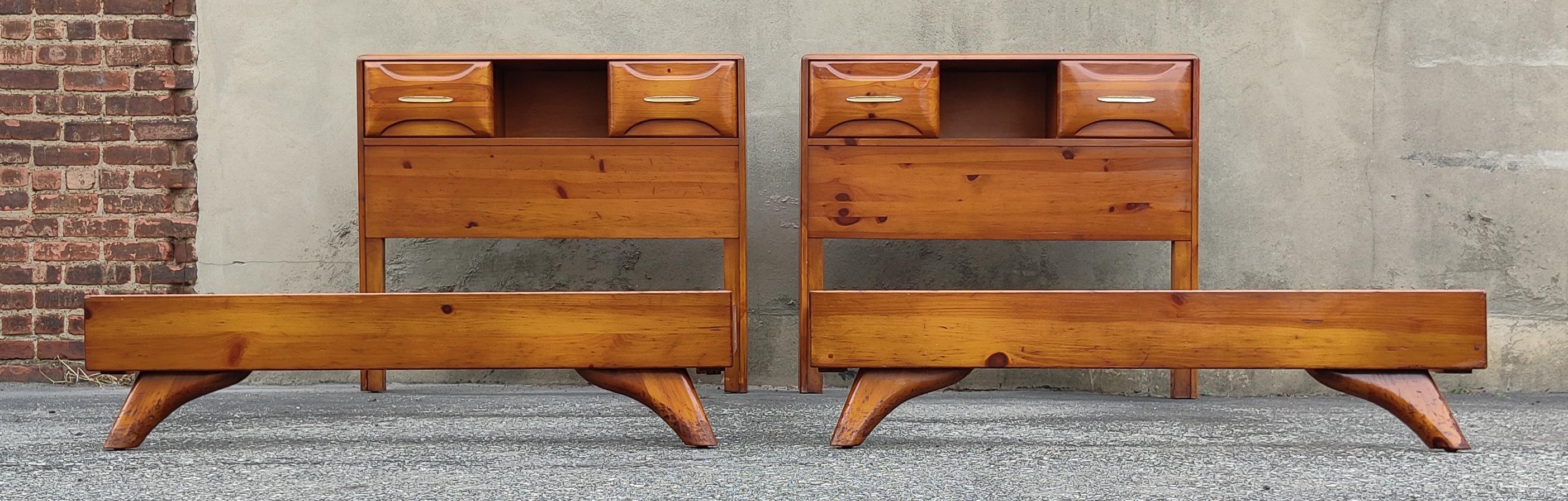 Two beds and single nightstand were produced in the 1970s by the Franklin Shockey Company for their Sculptured Pine line of furniture. Featuring solid pine construction, these 2 beds + 1 nightstand have a light and warm golden pine color and