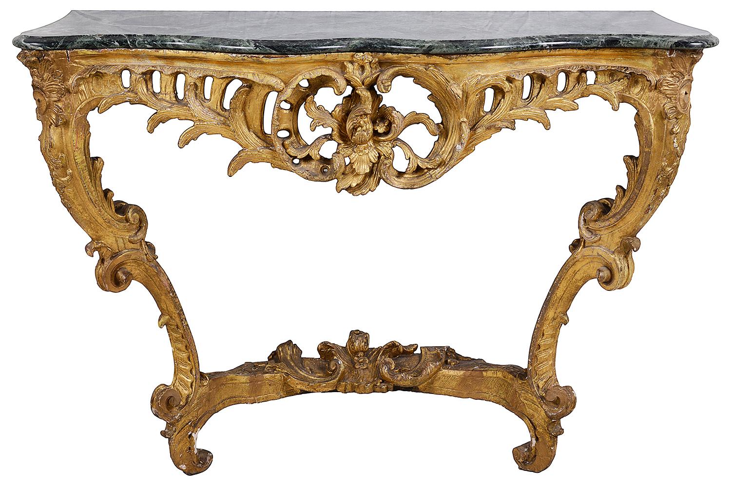 A good quality pair of French 18th century giltwood console tables, each with later green marble tops. wonderful carved and pierced scrolling foliate decoration, united by a stretcher below.