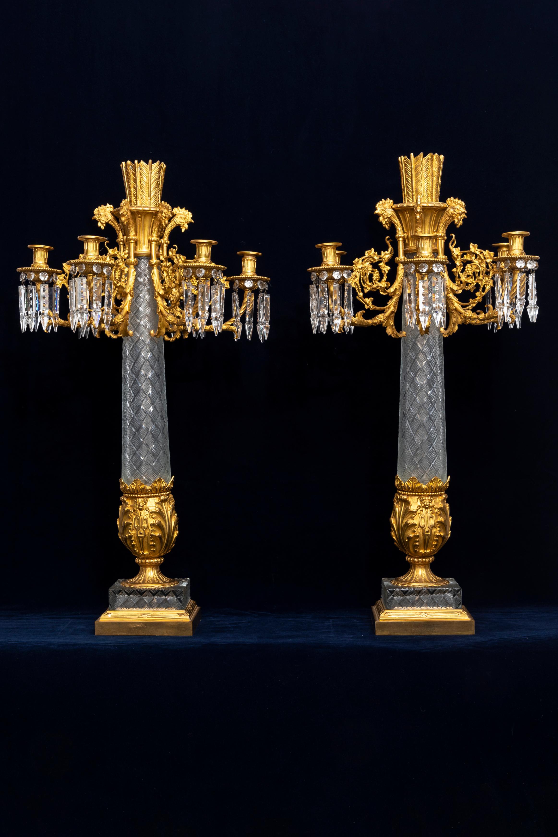 A Monumental Pair of French 19th Century Cut Crystal and Dore Bronze Multi-Arm Candelabra with Rooster Heads.  This ornate, extravagant pair of monumental bronze candelabras exemplify French empire taste and the style of King Louis XVI.  Standing on