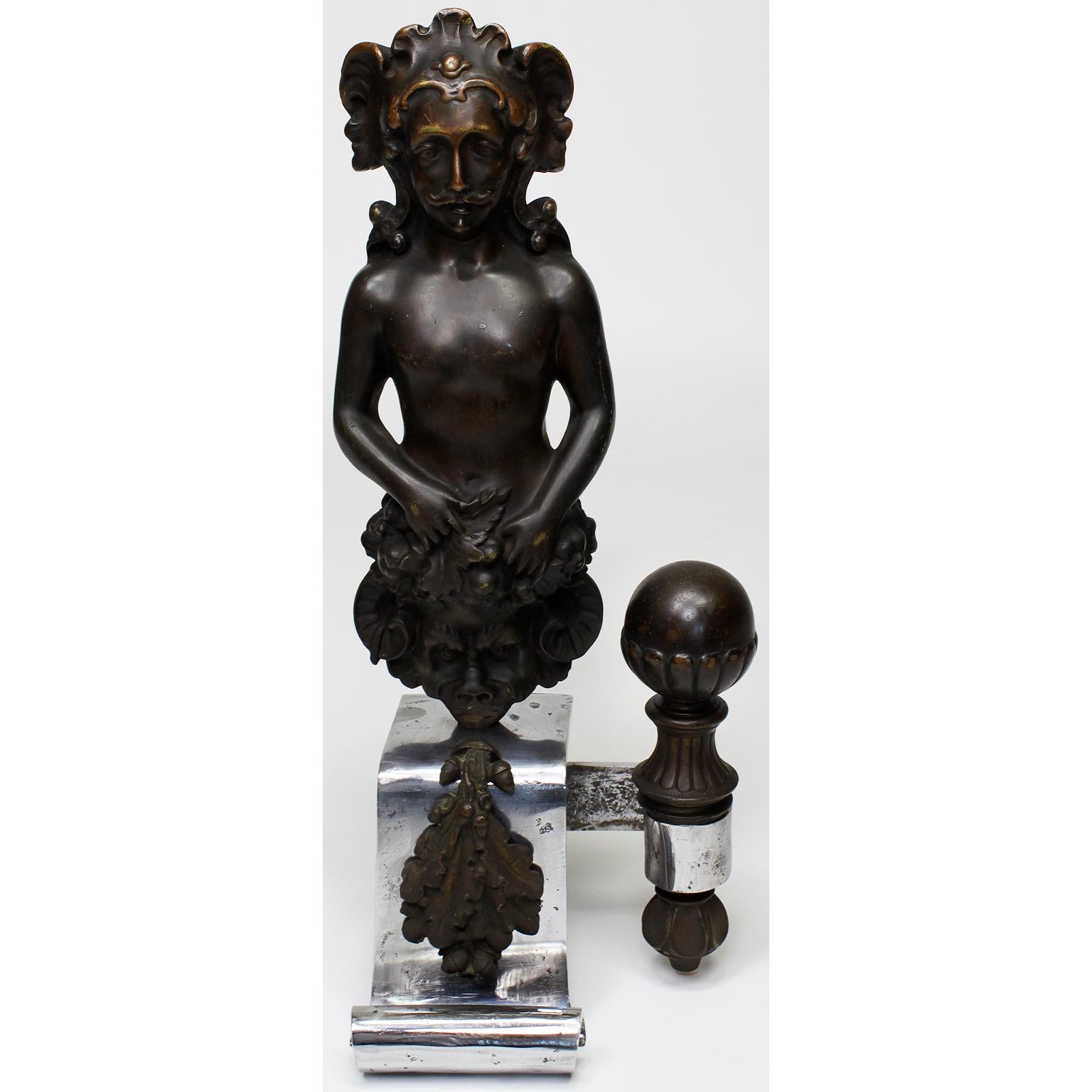 A pair of French 19th century Baroque Revival style steel and patinated bronze figural chenets (Andirons). Each with a posing male figure holding a satyr shield next to decorative sphere, both with wrought iron log-supports, circa