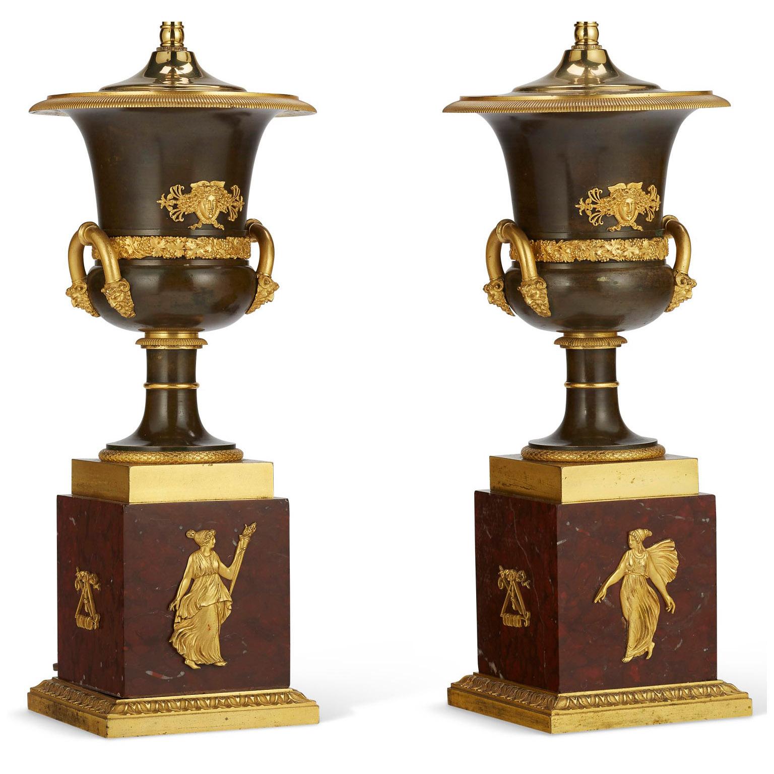 A very fine pair of French 19th century Napoleon III Empire style patinated-bronze and gilt-bronze Mounted Allegorical covered Urn vases lamps in the manner of Pierre-Philippe Thomire (French, 1751–1843). The ovoid campana-shaped patinated brass
