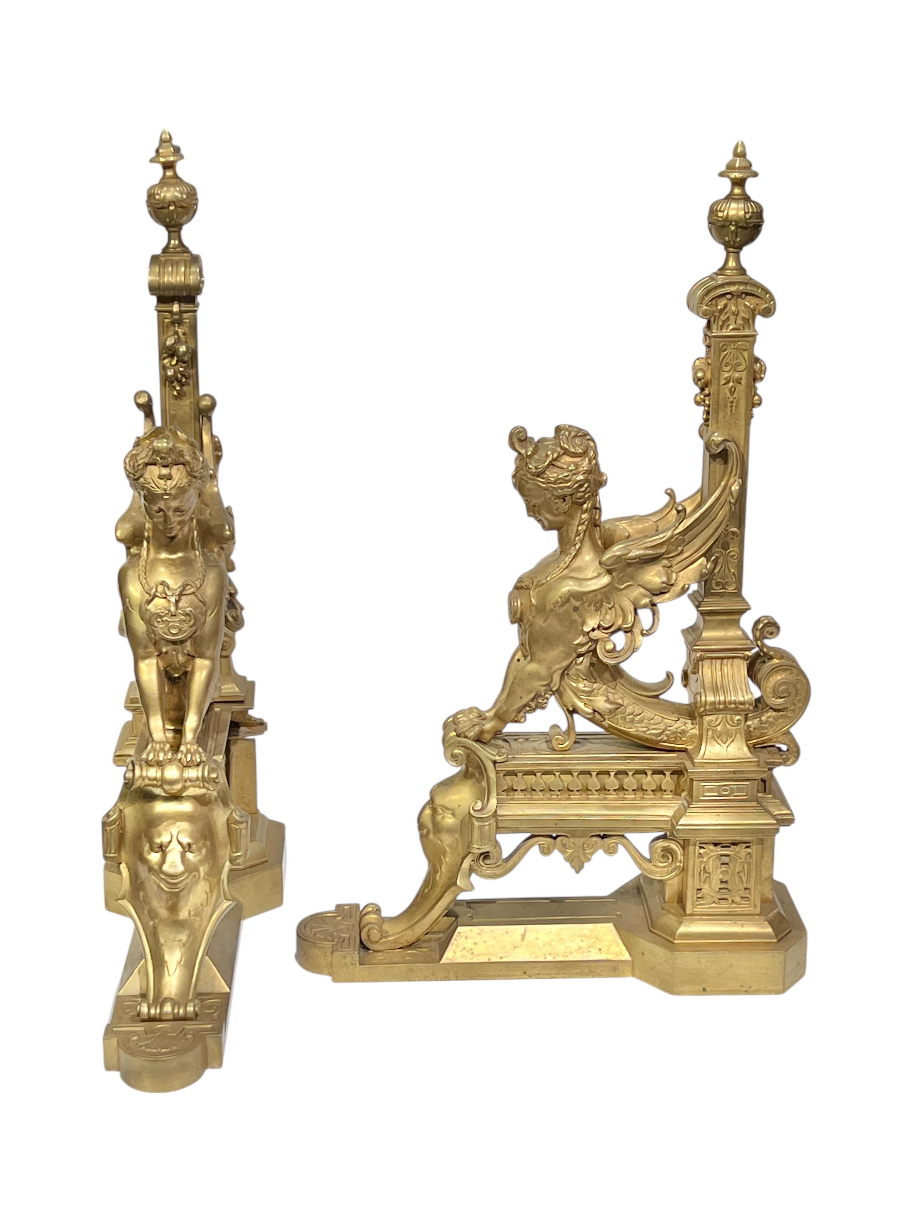 Pair of finely modeled and cast gilt bronze andirons (chenets) in the neoclassical style measuring 21 1/2 inches tall, 5 in wide and 13 1/2 in deep.