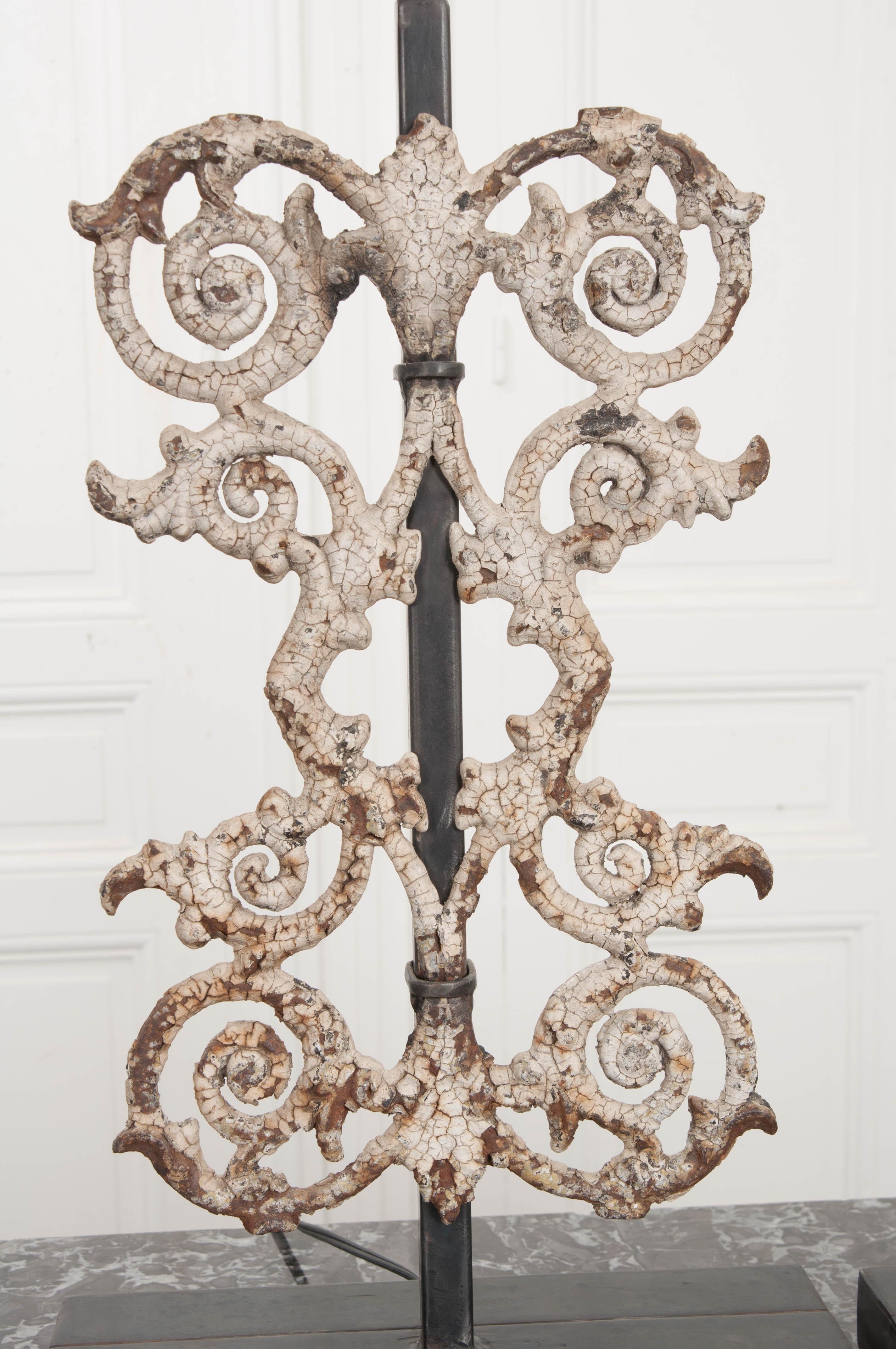 This lovely pair of 19th century French wrought iron fencing fragments are painted white and nicely oxidized. They are now mounted as table lamps on stylish and newly-made plinth bases. Wired for the US according to UL standards and accompanied by