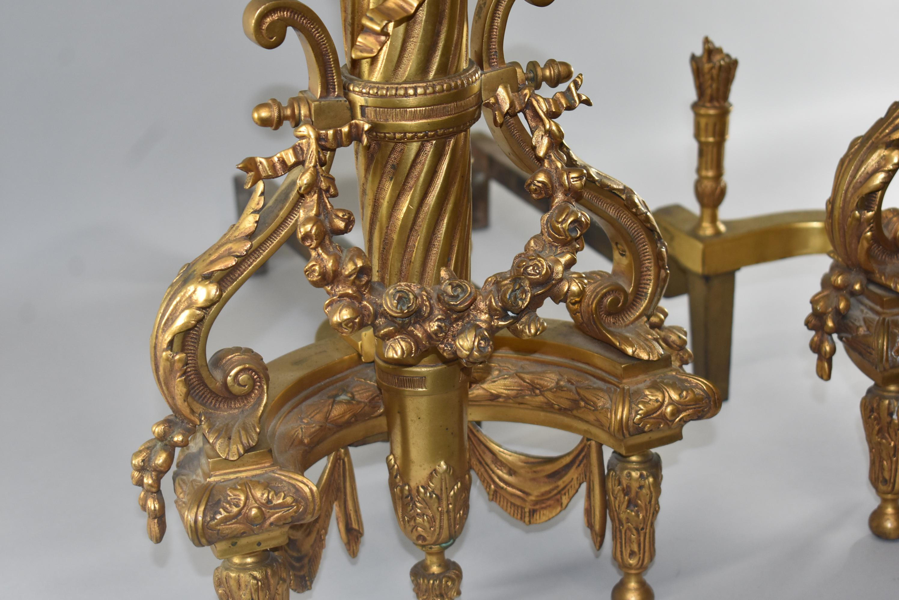 Pair of gold doré' French andirons with arrow and quiver details. Very nice condition. Dimensions: 24