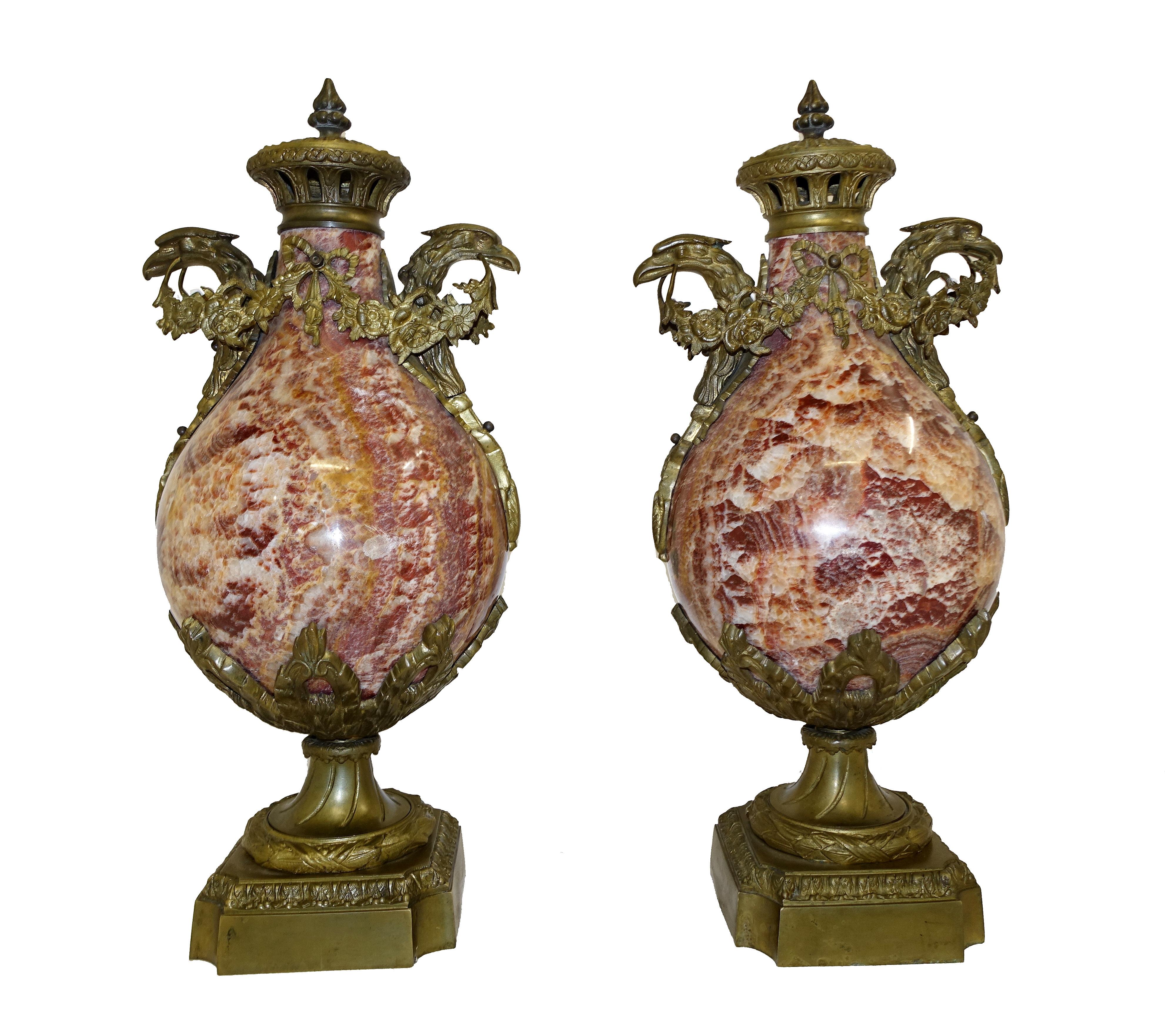 Elegant pair of antique marble urns - or cassolettes
Great bulbous form to the body of the urn
Love the colour scheme with burnt orange, deep reds and ochre to gorgeous affect
Ormolu fixtures all original including birds head handles Stand out pair