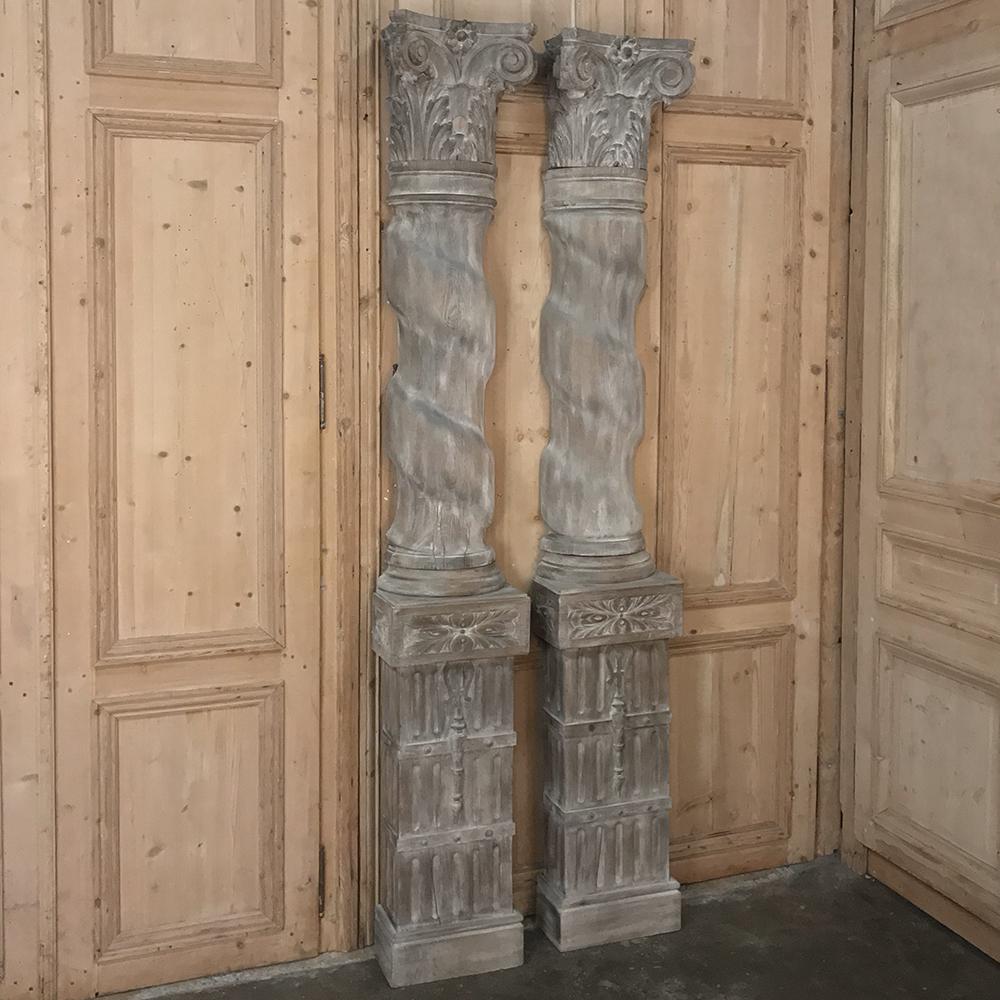 Pair of 19th century French architectural weathered oak hand carved columns. Grand and stately solid oak columns with rectangular carved pedestal bases, barley twist Italianate upper sections and Corinthian capitals, circa 1890s.
This intriguing