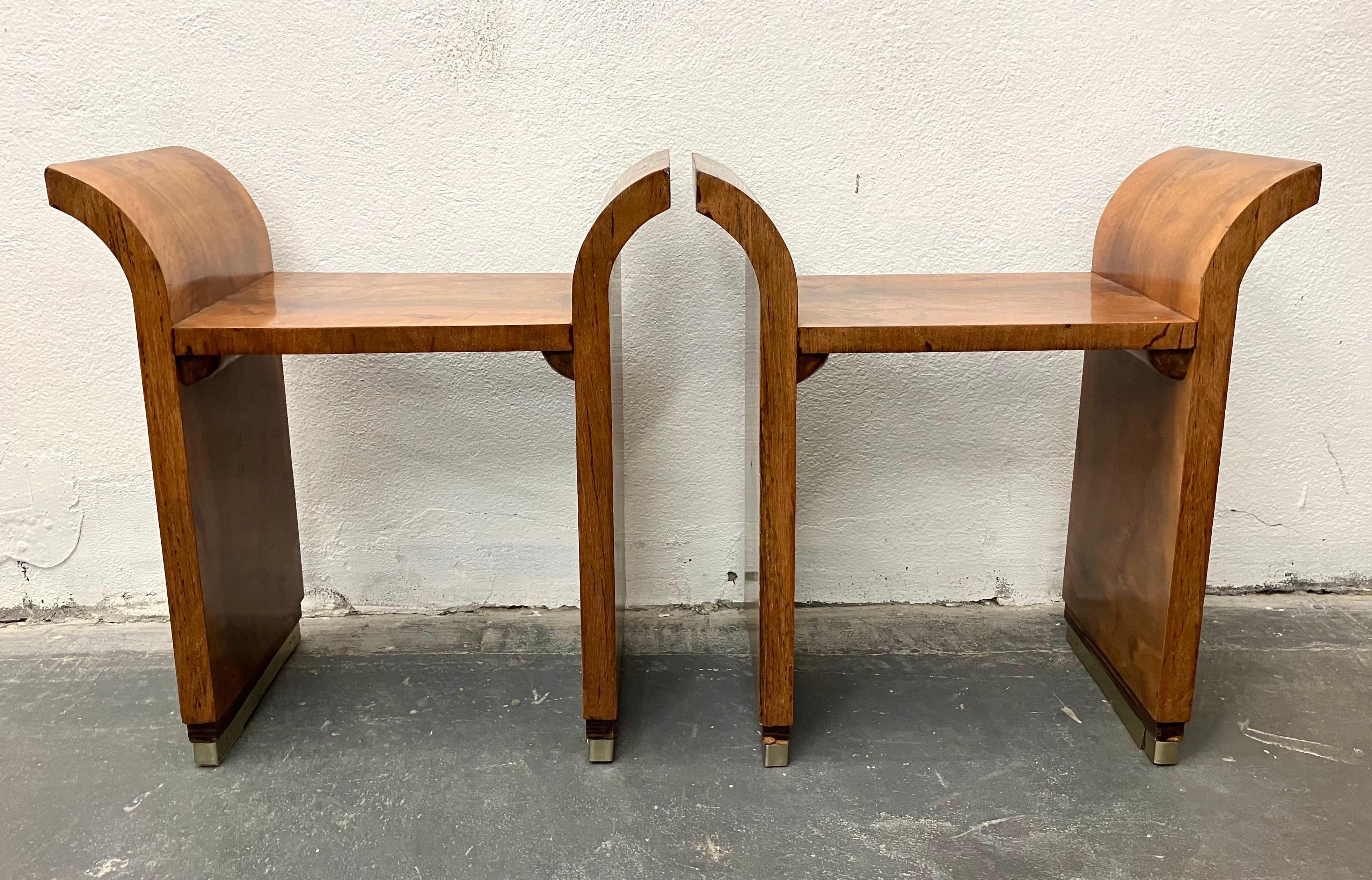 Modernist period French Art Deco curule-form stools in figured walnut with aluminum and Macassar Ebony banded feet. Unmarked but in the style of Pierre Chareau or Jacques Adnet.