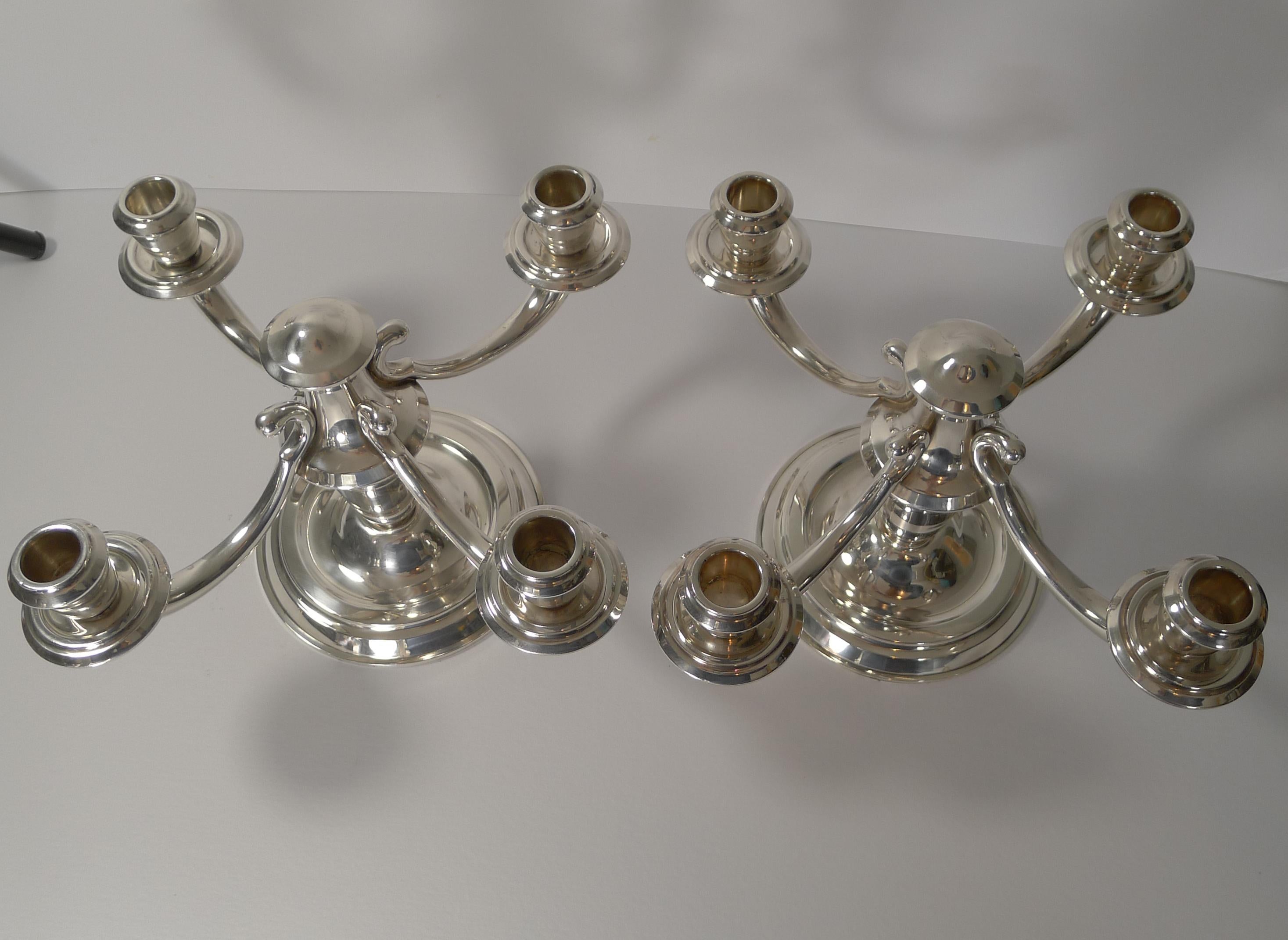 A very stylish pair of Art Deco silver plated four-arm candelabrum dating to the 1930s.

The underside of each is signed by the well renowned silversmith, Ravinet d’Enfert of Paris.

The company founded in 1845 by E. Tonnelier was acquired in