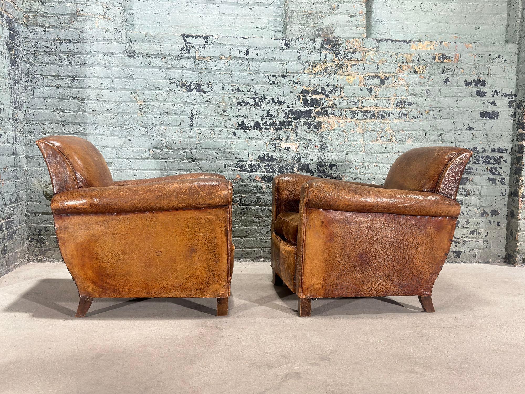 Pair French Art Deco Leather Lounge Chairs, 1930. Nicely worn original leather with beautiful patina/distressed.
Chairs measure 31