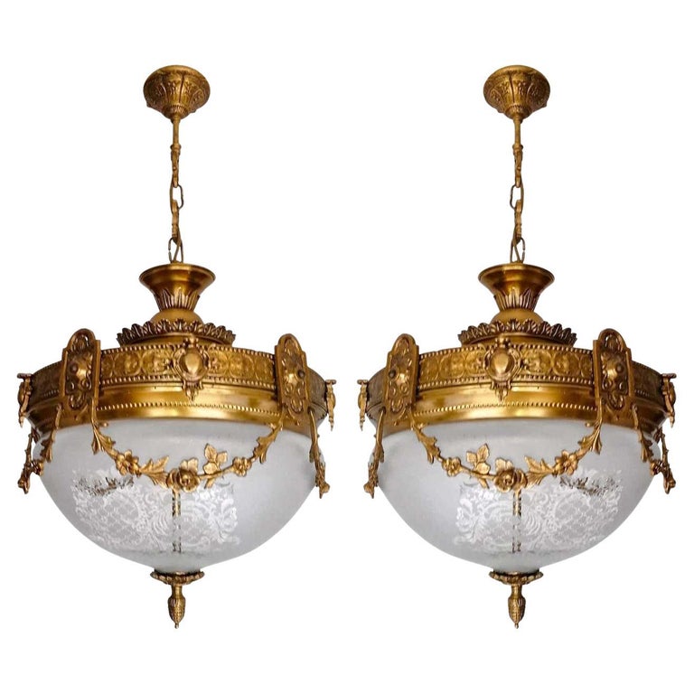 A pair of wonderful gilt bronze and etched-glass two-light ceiling fixture decorated with Fine ornaments and garlands, France, early 20th century.
In very good condition - original etched-glass shades without damages, bronze with beautiful