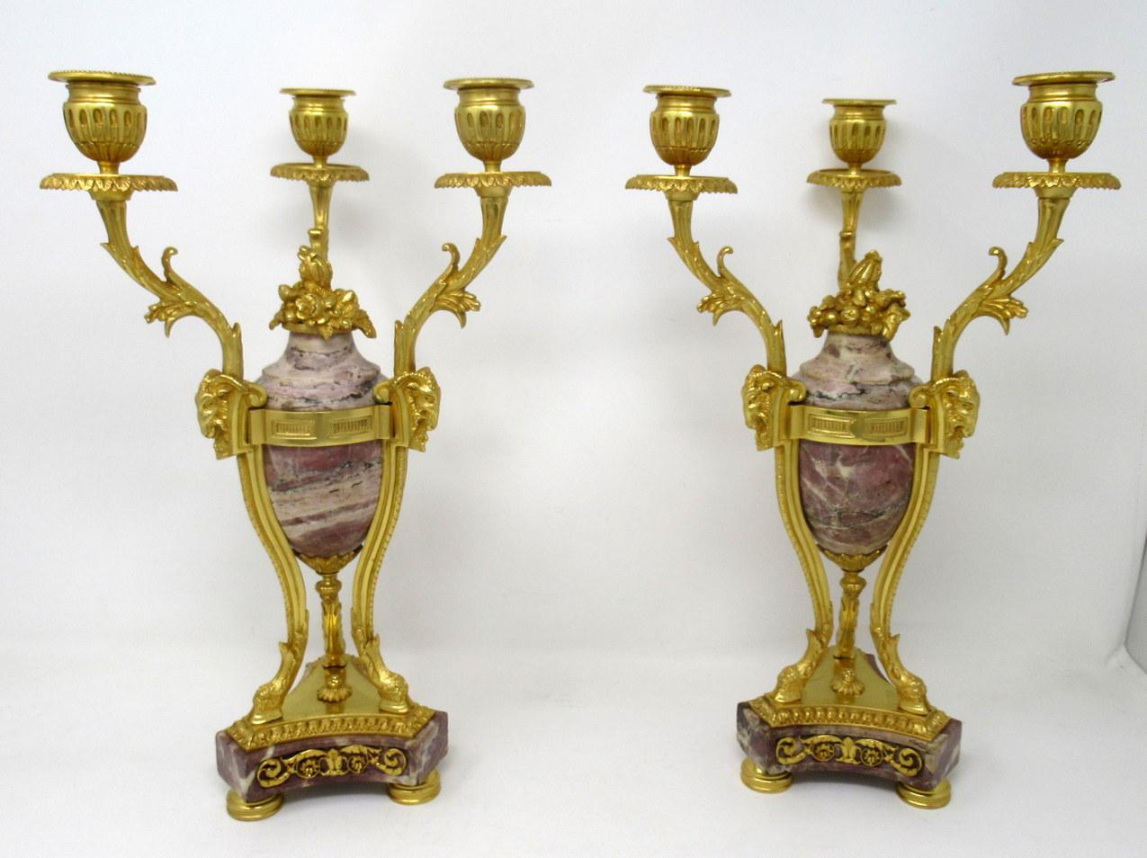 Stunning pair of French Ormolu and Breche Violet marble three-arm candelabra of generous proportions, attributed to Pierre-Philippe Thomire, made during the second quarter of the 19th century.

The three foliate outswept arms spreading from a