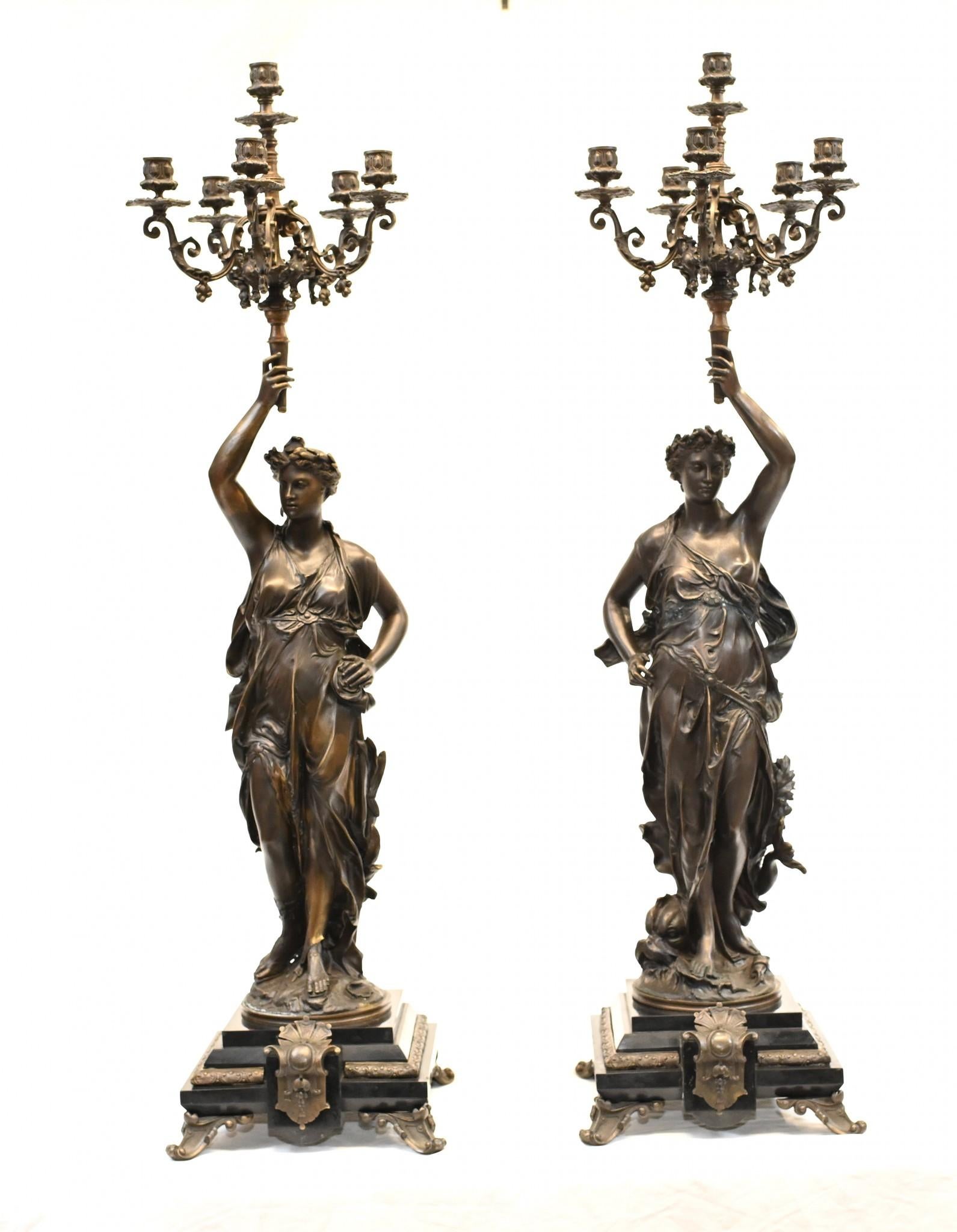 Absolutely stunning pair of French Bronze candelabras by Gregoire
Each figurine holds aloft the five branch candelbras
Casting is superb and and the patina to the bronze is wonderful
Each stand in at over three feet tall - so an impressive