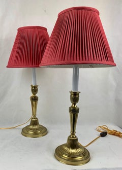 A Pair of French Bronze Candlestick Lamps with Hand Sewn Red Silk Shades