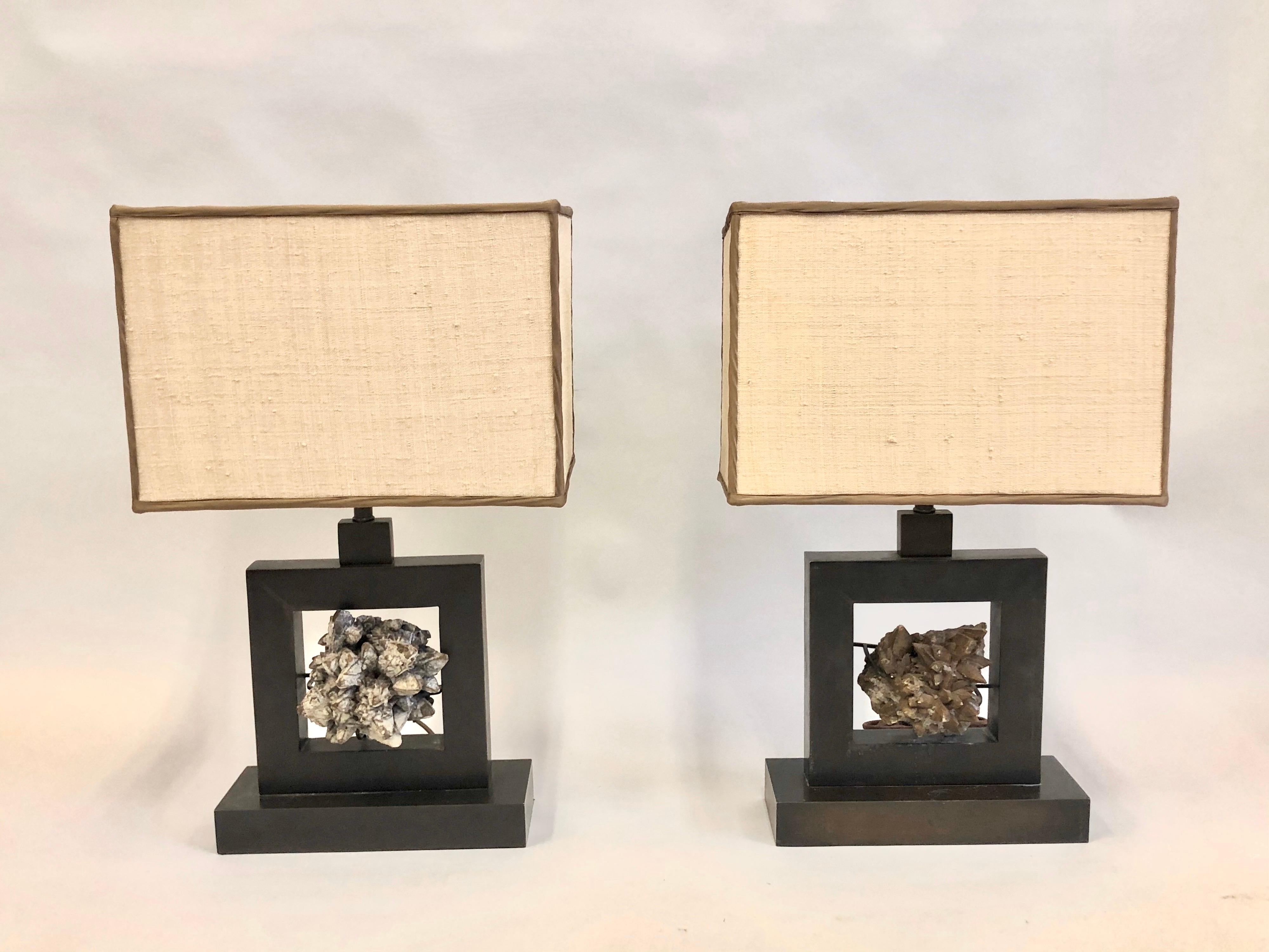 Elegant, rare and timeless pair of mineral crystal geode table by the renowned French mid-20th century interior designer and architect, Marc Duplantier. The raw rock crystal is delicately set in sober, handmade, bronzed wrought iron table lamp bases