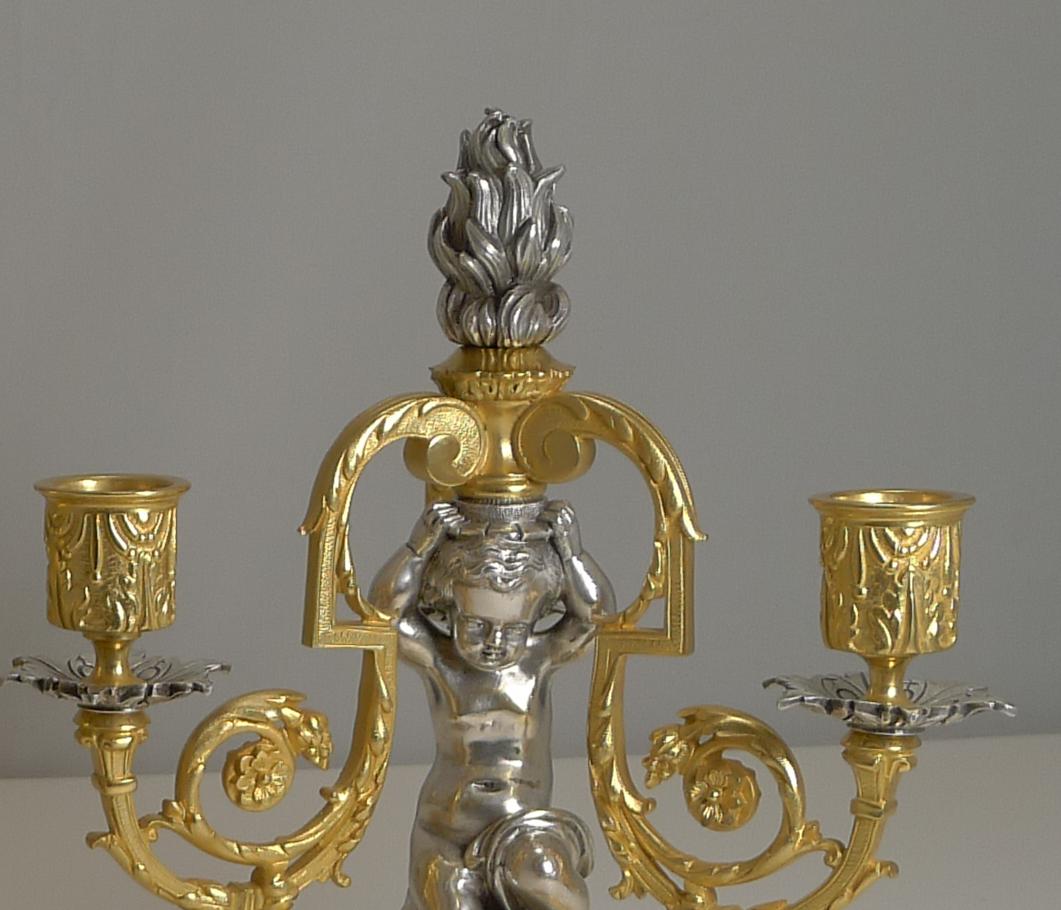 A most magnificent pair of late Victorian three-branch candelabra dating to circa 1870. Having been lovingly professionally restored, the ormolu and silvered finishes are now bright and clean showcasing the charming central Cherub or Putti