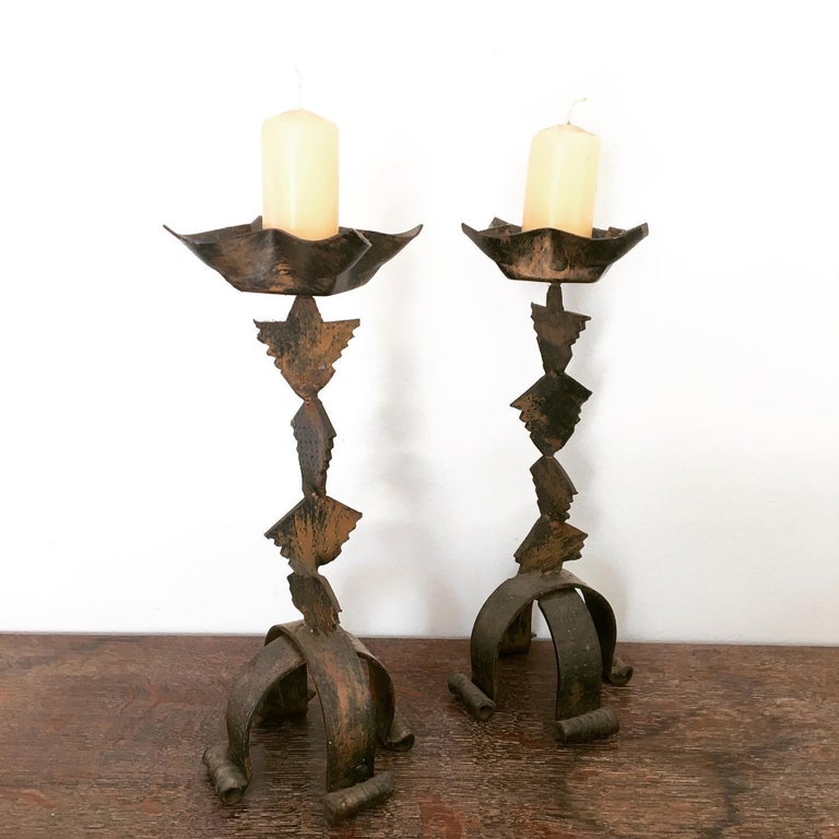 A pair French Brutalist forged iron table candle stands, a strong addition to any room. The craftsmanship is really wonderful, showing the connection between make and user. A strong use of geometric shapes and curved quartruped feet.