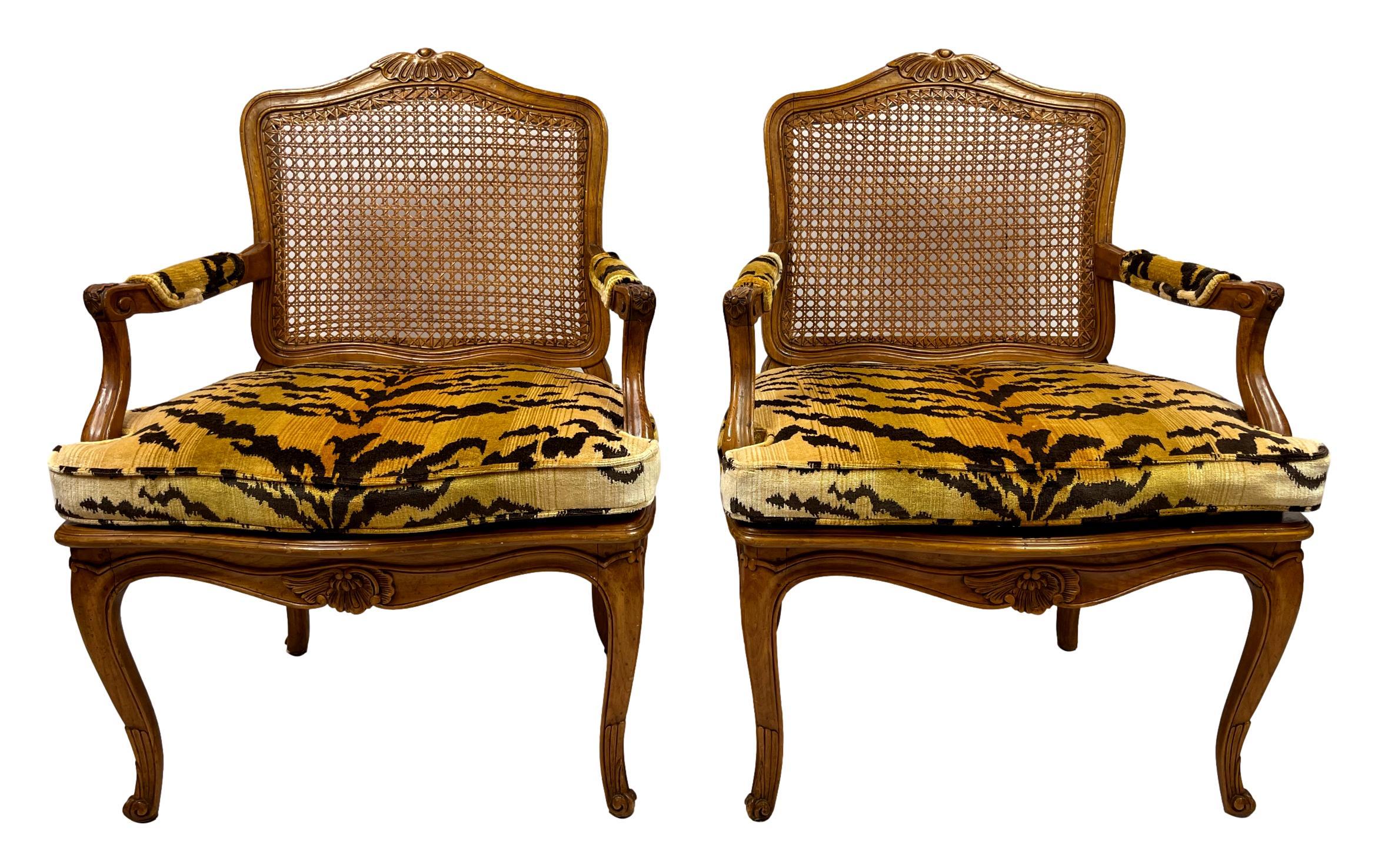 Pair of Louis XV-style carved fruitwood and caned fauteuils, French, ca. 1920, newly upholstered in the best silk tiger velvet, hand-loomed in Italy, with new custom-made cushions, perfectly flow-matched on both sides, with a hidden zipper in the