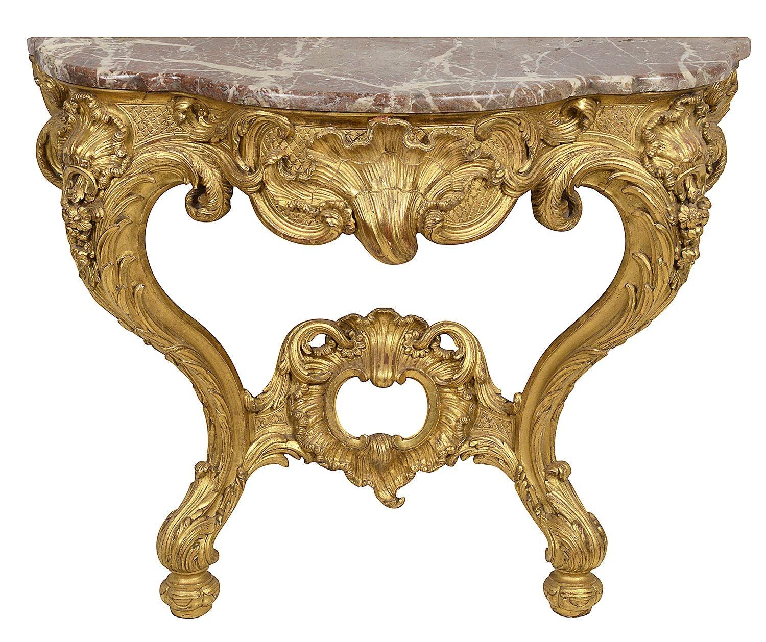 A very good quality pair of 19th century French carved giltwood console tables. Each having their original Levanto rouge marble tops, wonderful classical scrolling foliate and shell like decoration, raised on elegant cabriole legs, united by a