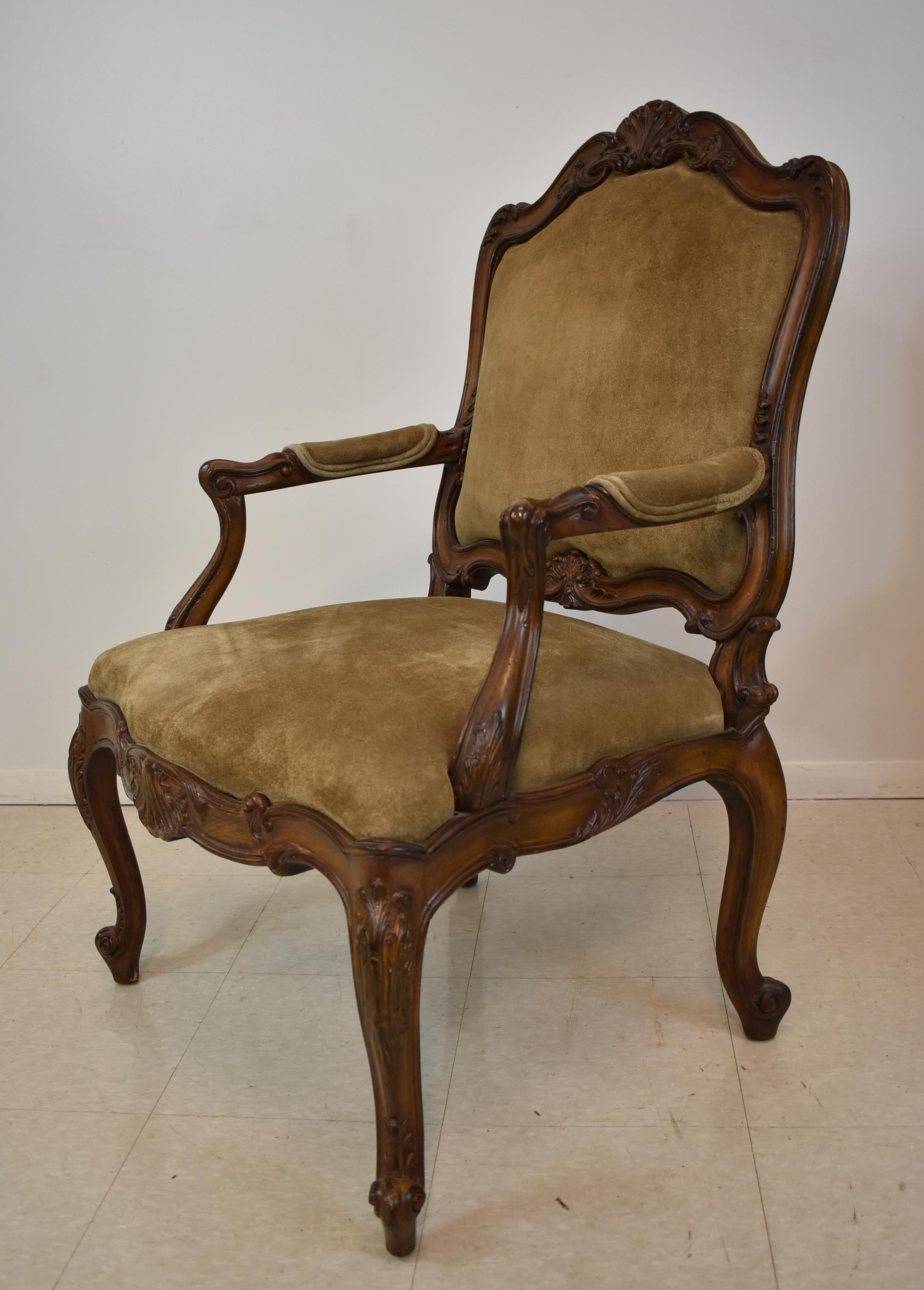 Pair of French carved wood armchairs with suede upholstery.