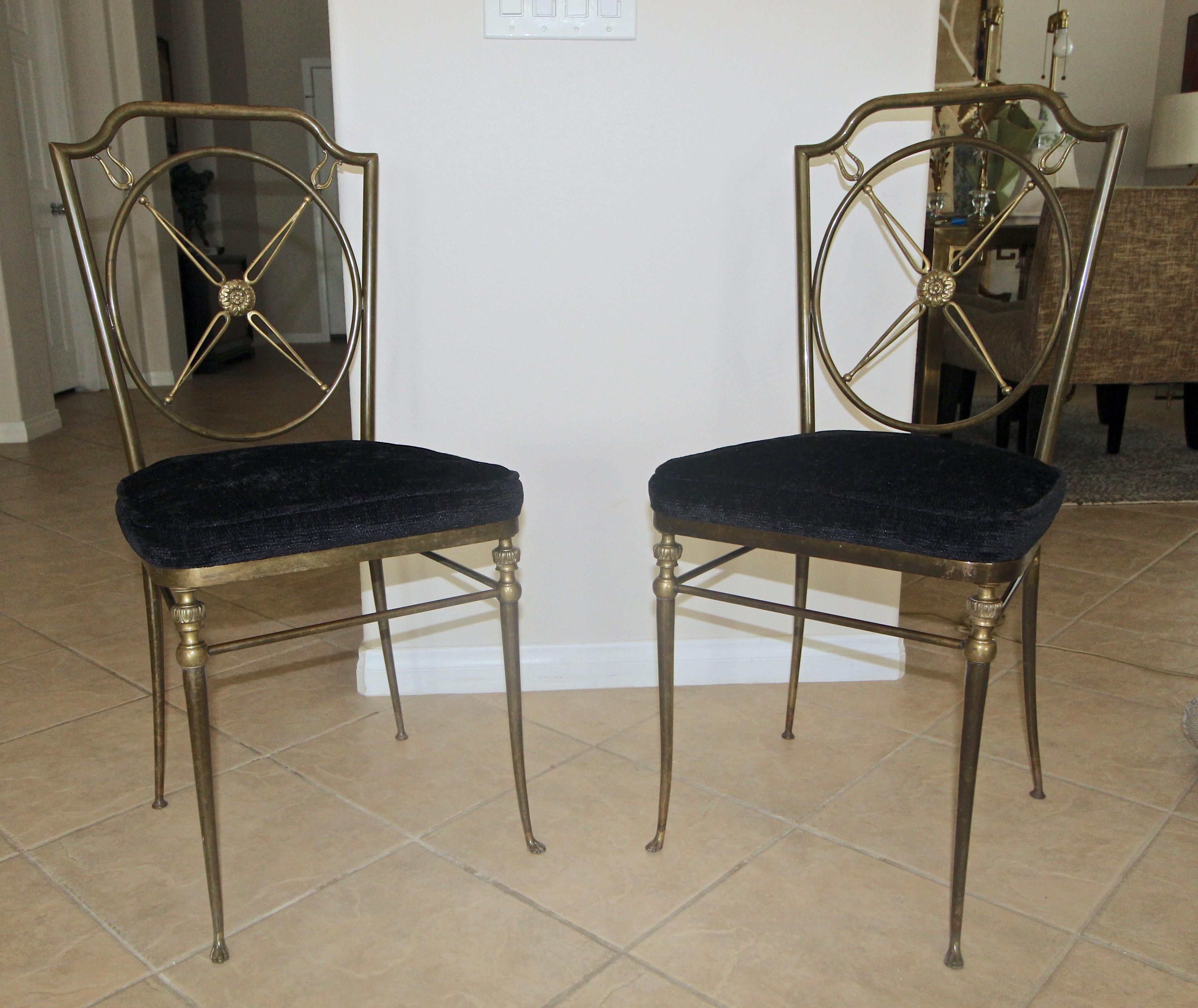 Magnificent pair of French directoire style bronze side or hall chairs. The chairs have a beautiful original warm aged patina. Expertly crafted detailing through out including delicate paw feet, and a “X” motif with center paterae. The upholstering