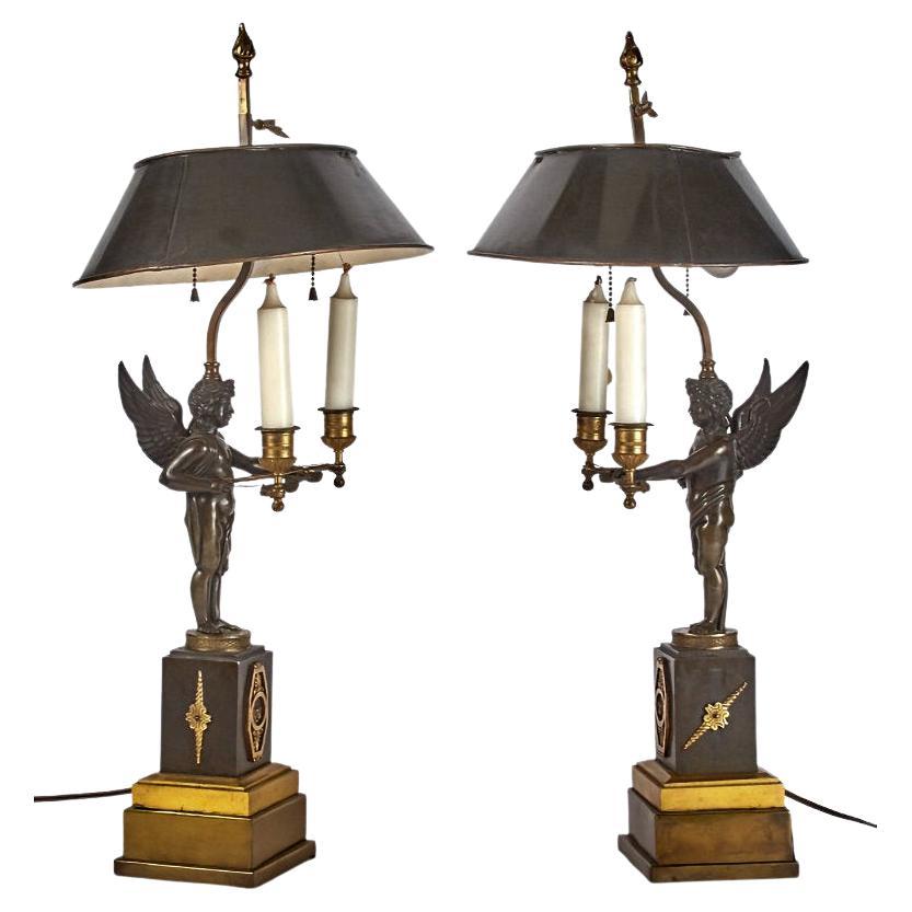 Pair of 19 century French Empire figural two tone bronze Bouillotte lamps with painted tole shades.