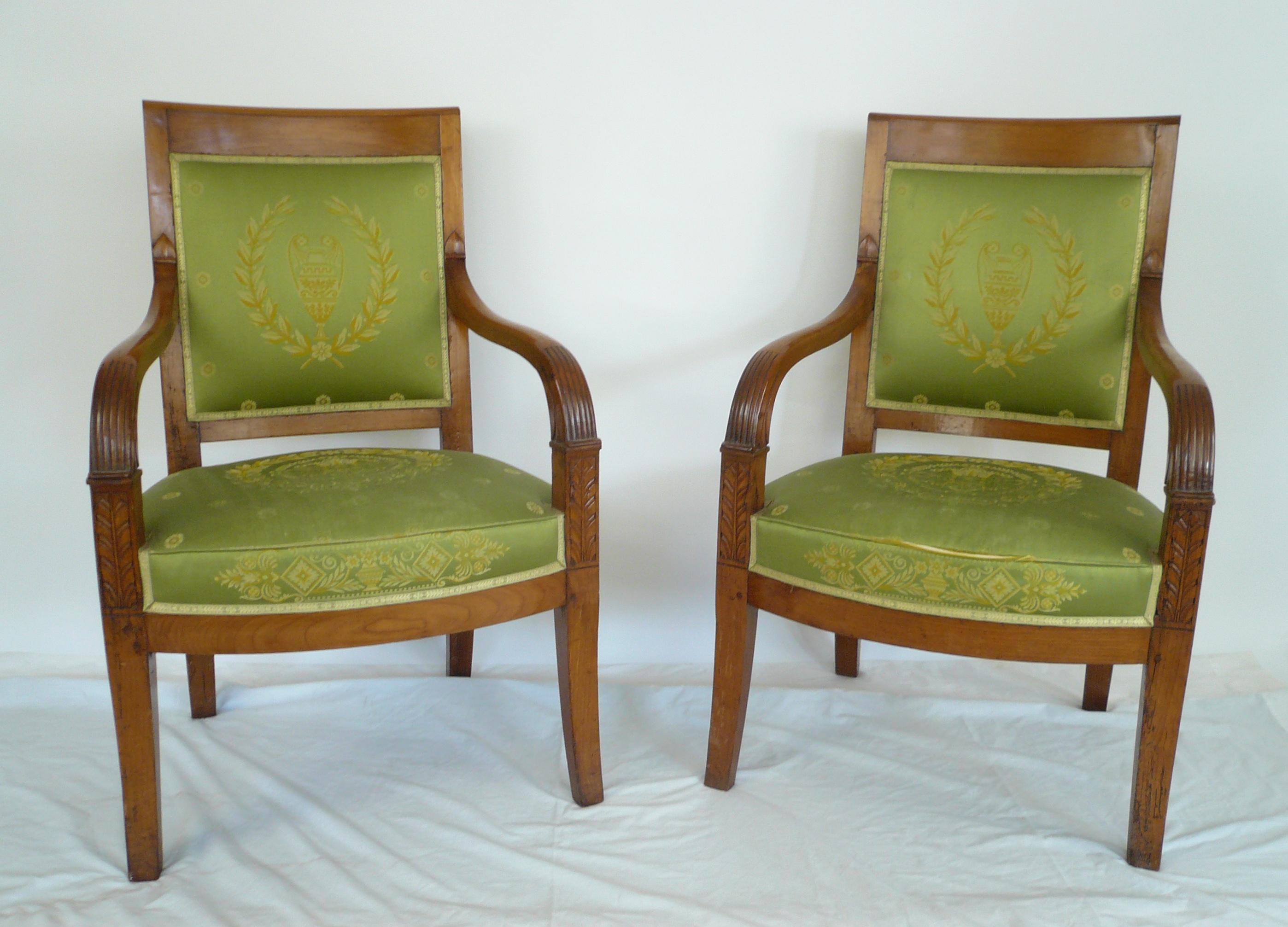 This pair of 19th century fruitwood armchairs feature carved acanthus leaves and reeded arms.