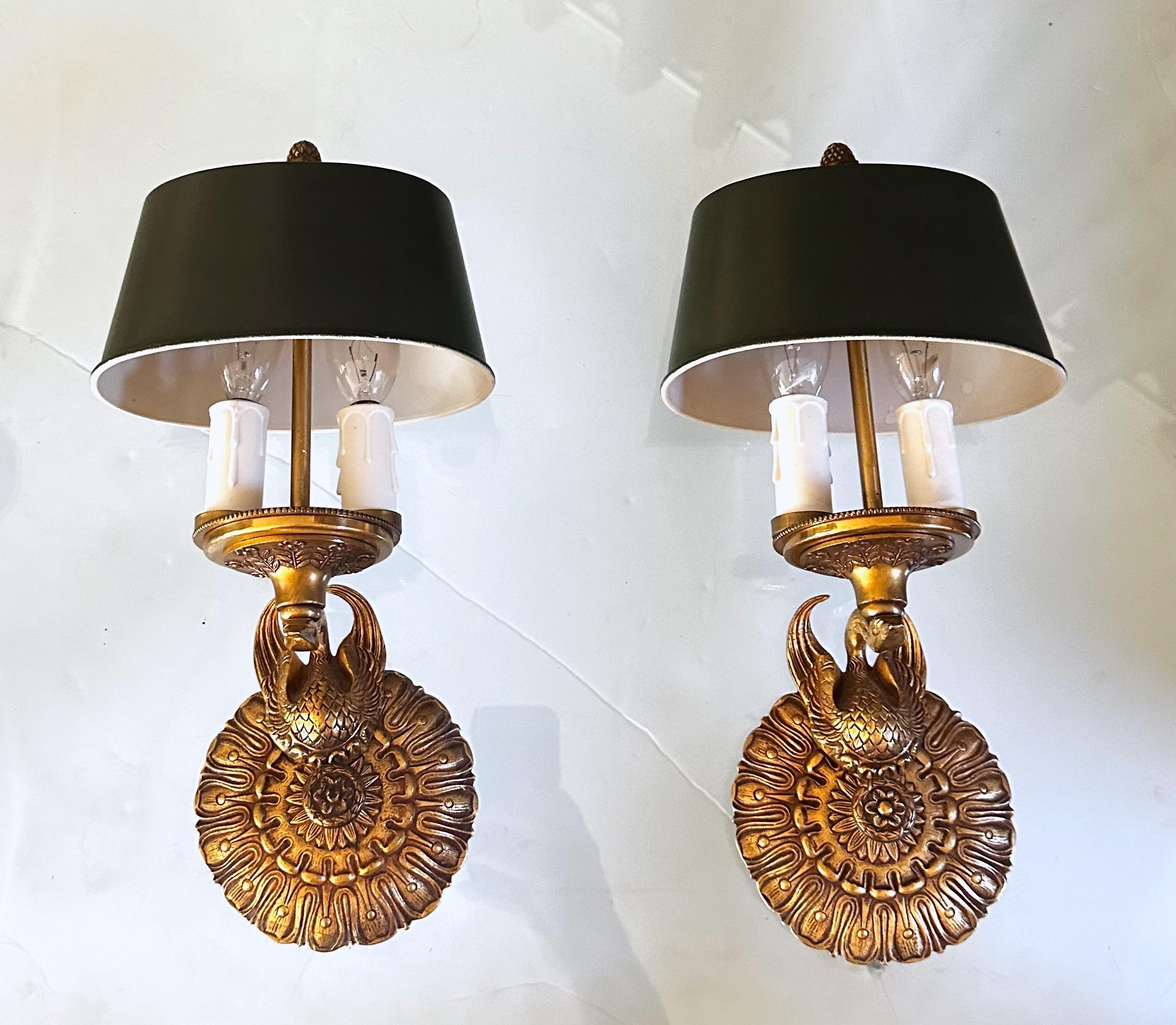 Pair of French Empire style bronze or brass wall sconces with green painted tole metal shades. Expertly executed with fine detailing including swan motif. Each sconce uses 2 candelabra size bulb.