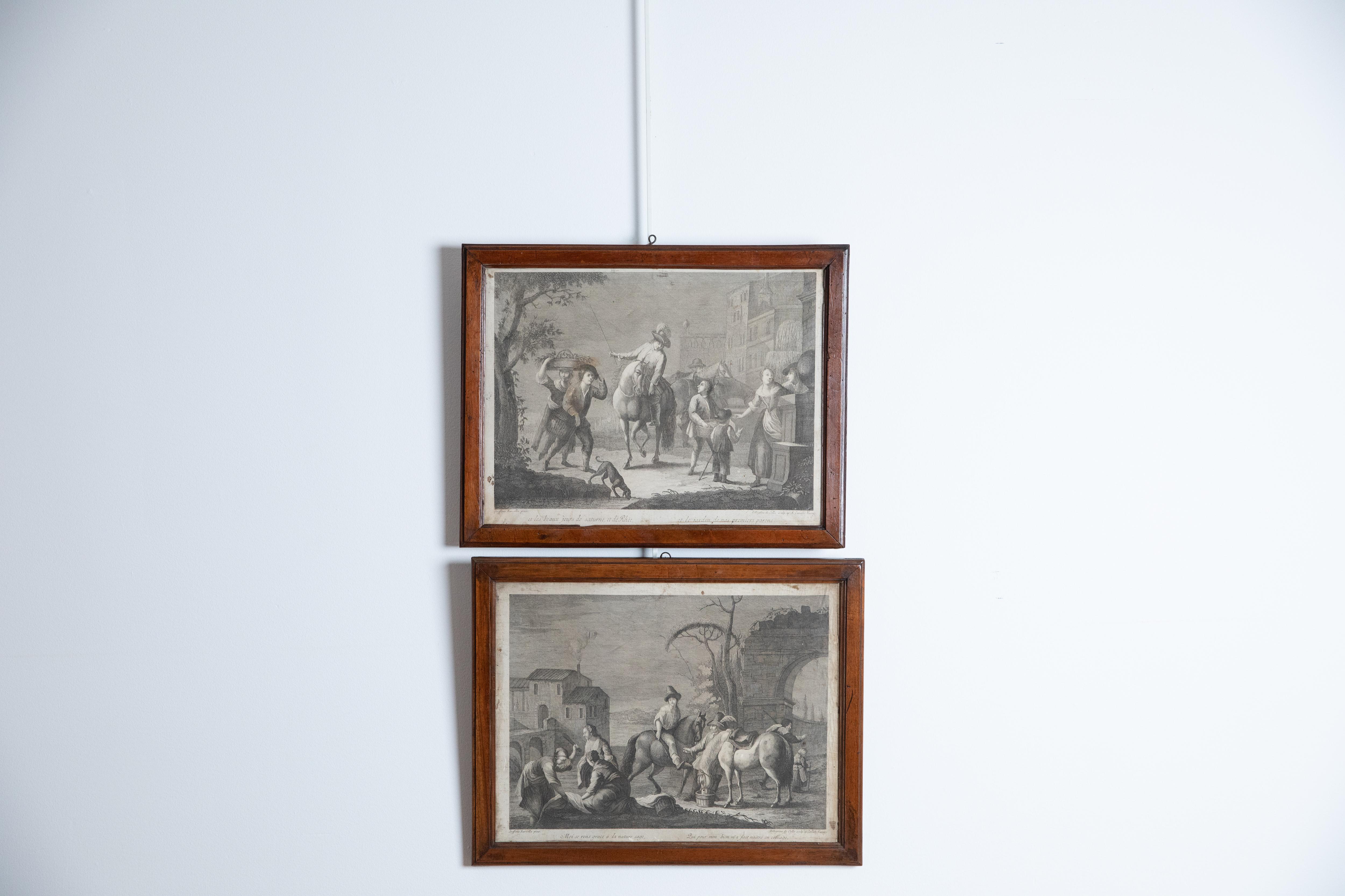 Each engraving depicting a typical street and genre scene, respectively, both  in antique walnut frames
