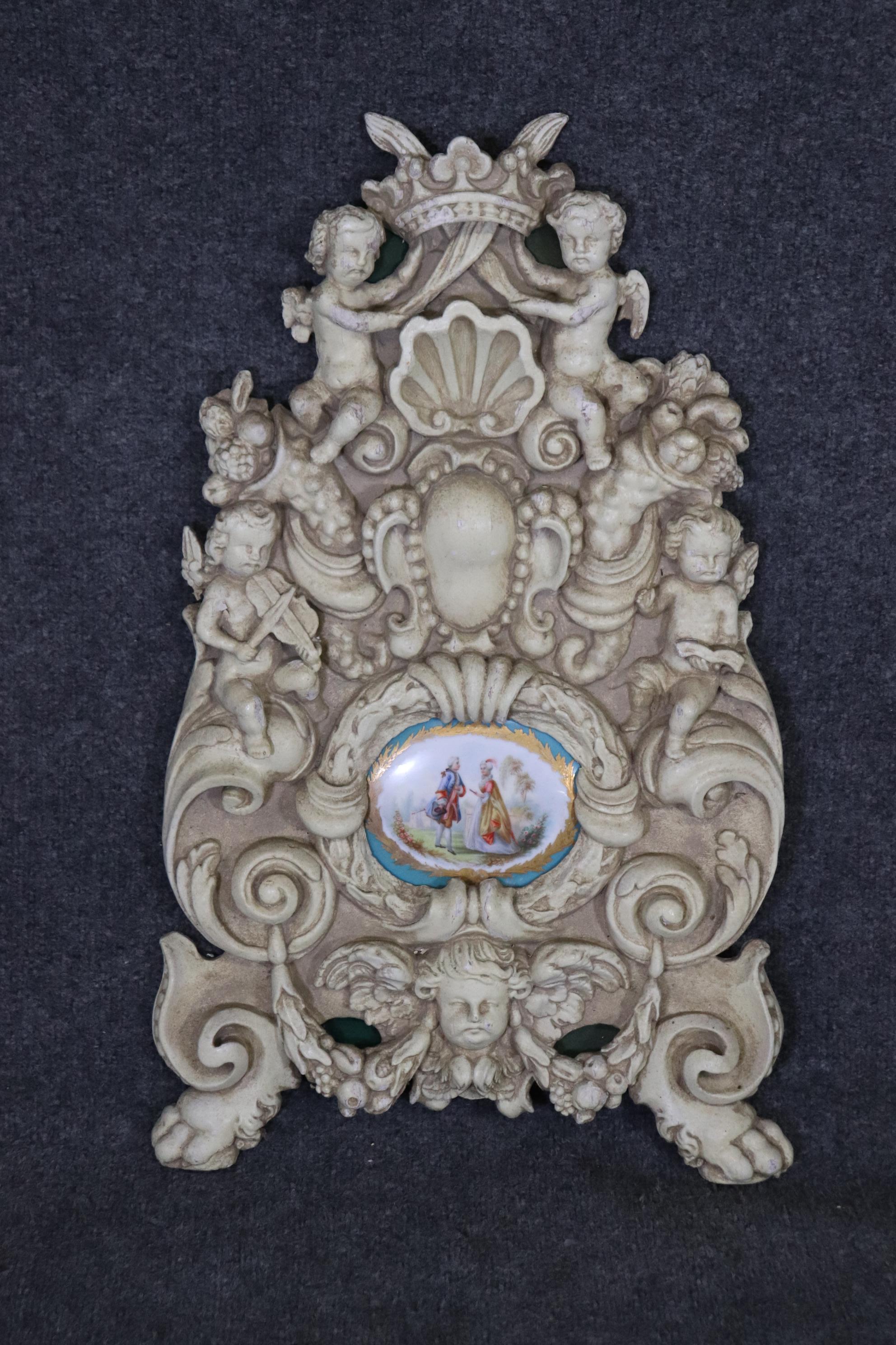 Dimensions- H: 26in W: 15 3/4in D: 2in
This Pair French Figural Carved Wall Decorations With Sevres Style Plaques are made of the highest quality and have a stunning look! This pair is made of wood and has a swedish finish to the carved figural