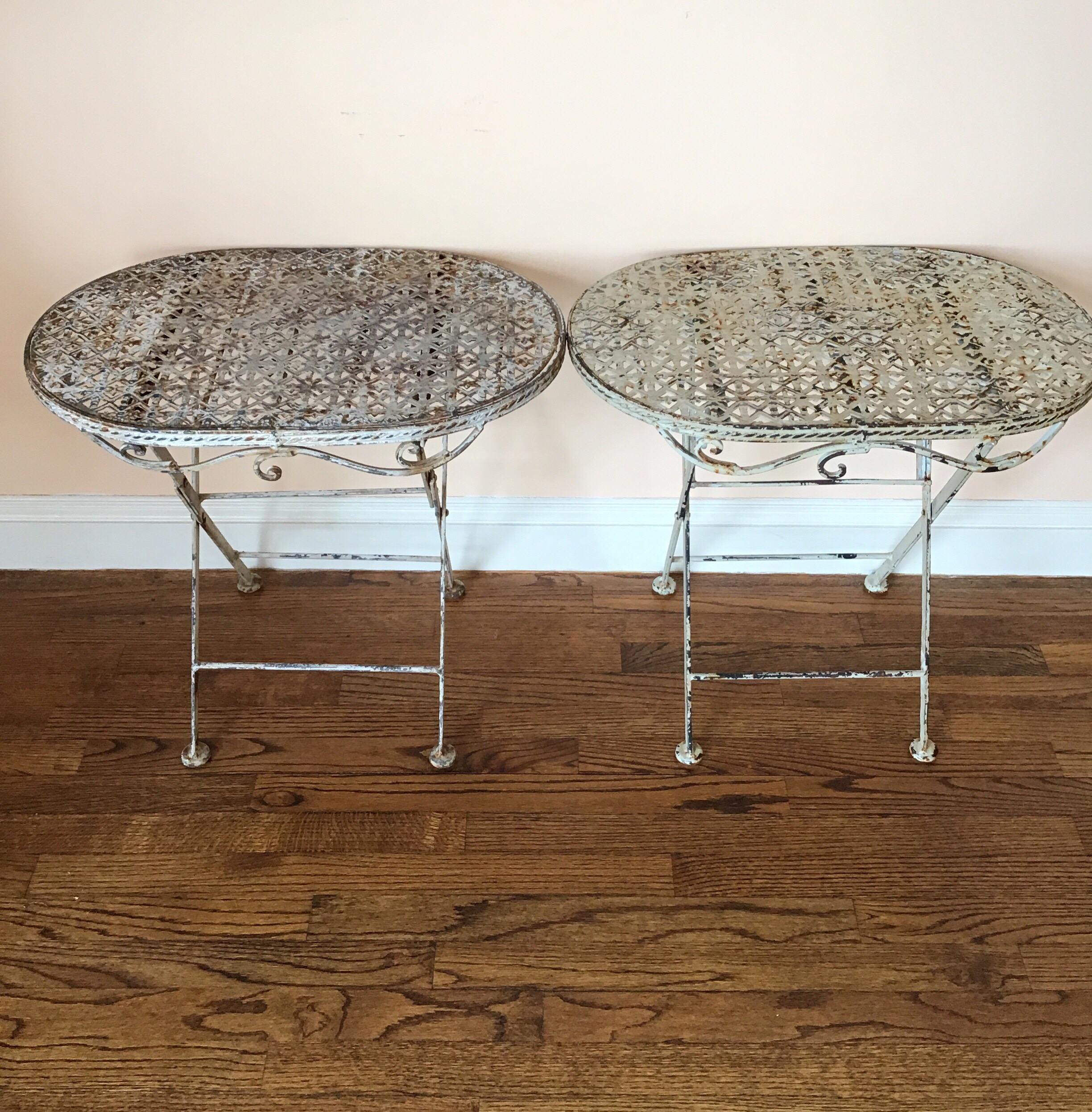 Handmade metal early 1920s French folding garden tables with decorative edging.