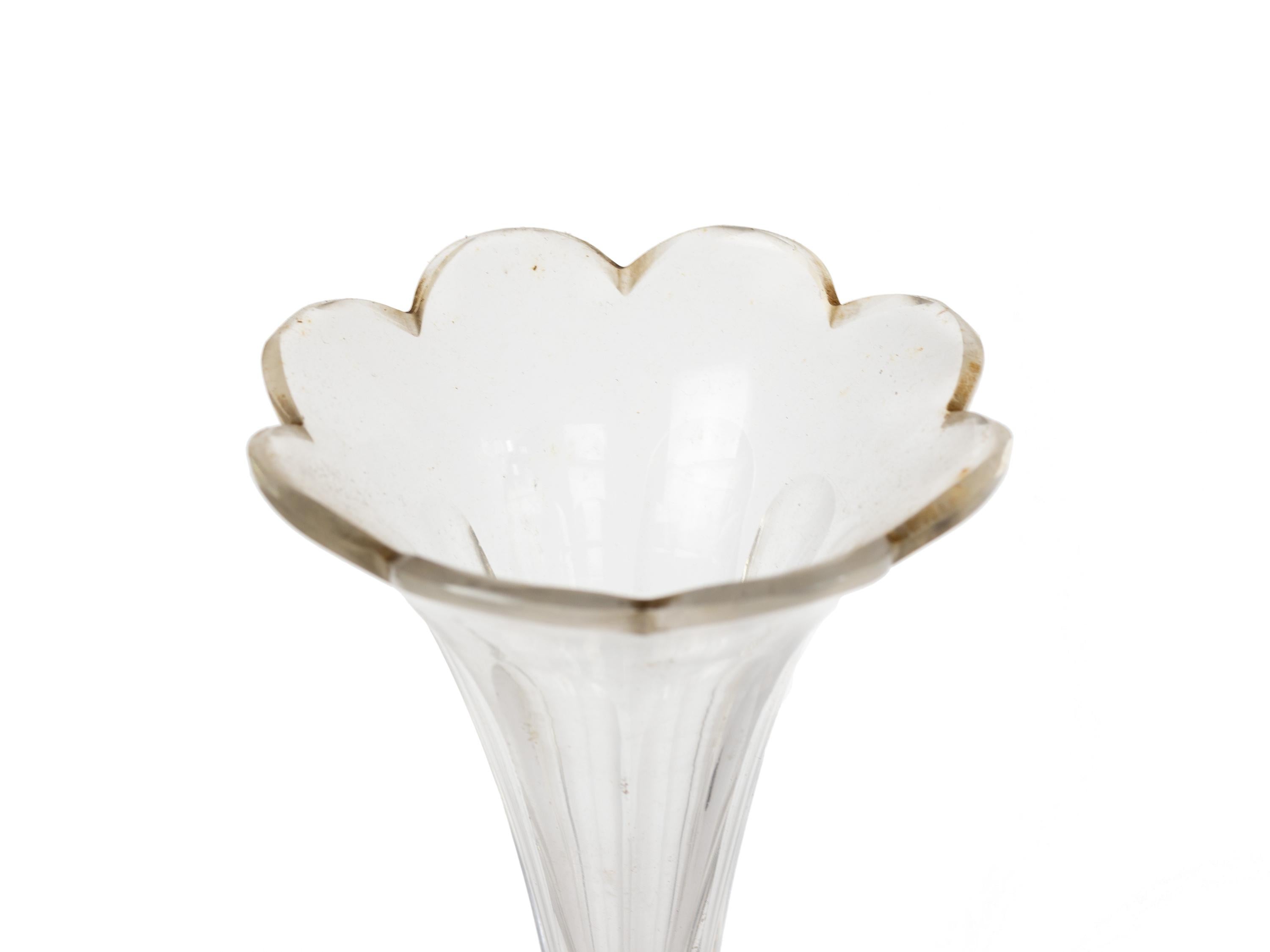 This pair of French trumpet-form vases dates from the late 19th century and blends two luxurious materials: engraved clear glass and richly decorated gilt bronze mounts with champlevé enamel detailing. 

The elegant trumpet-shaped glass tops rest