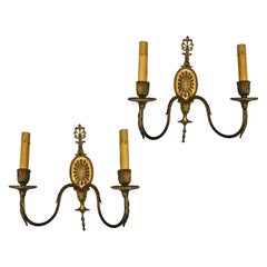 Coppia di sconsigliere neoclassiche francesi in bronzo dorato