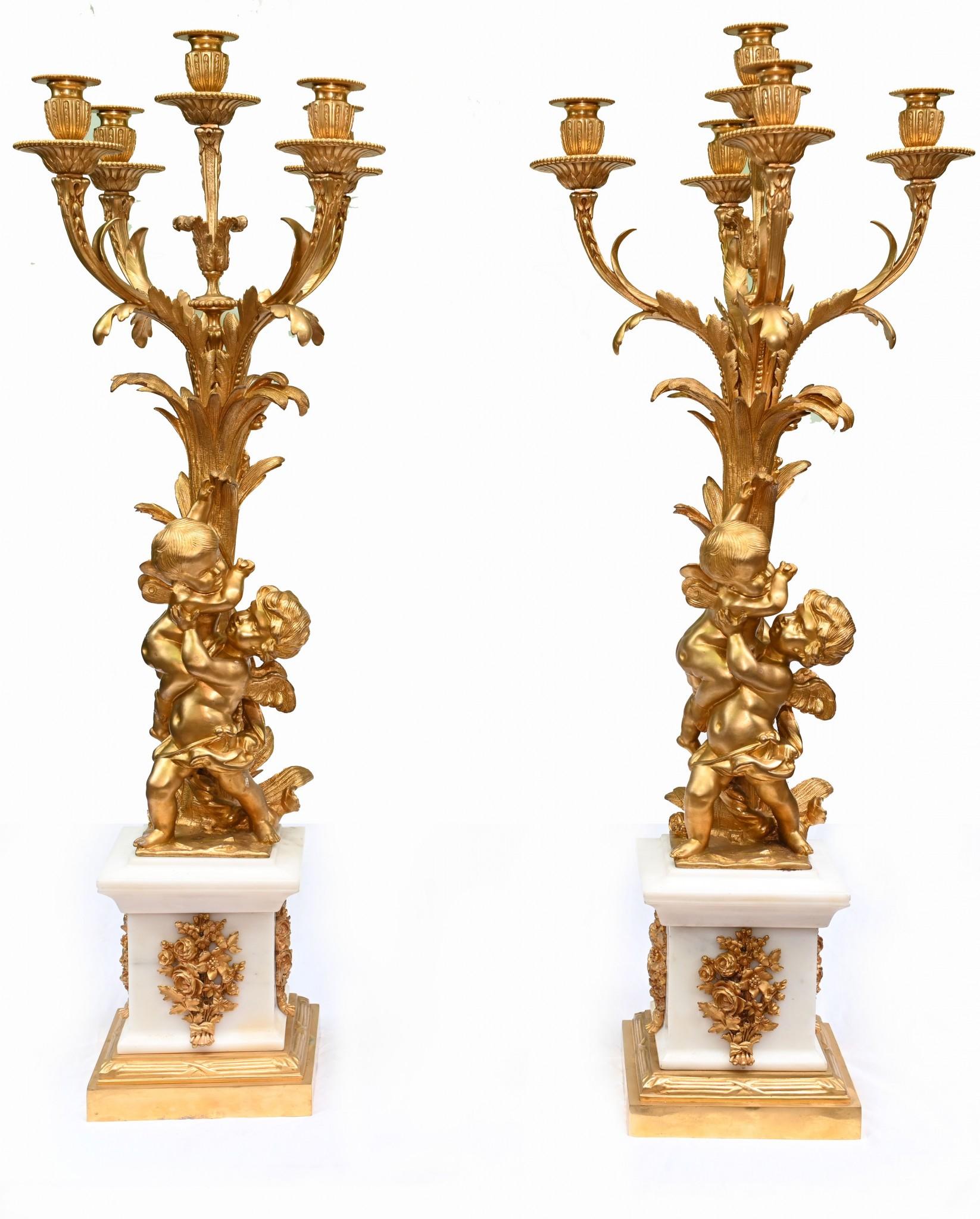 Stunning pair of large gilt and marble candelabras in the Clodion manner
Good size at just under three feet tall
So eye catching with the pair of cherubs intertwined holiding aloft the candelabra branches
The casting of the gilt is very detailed and