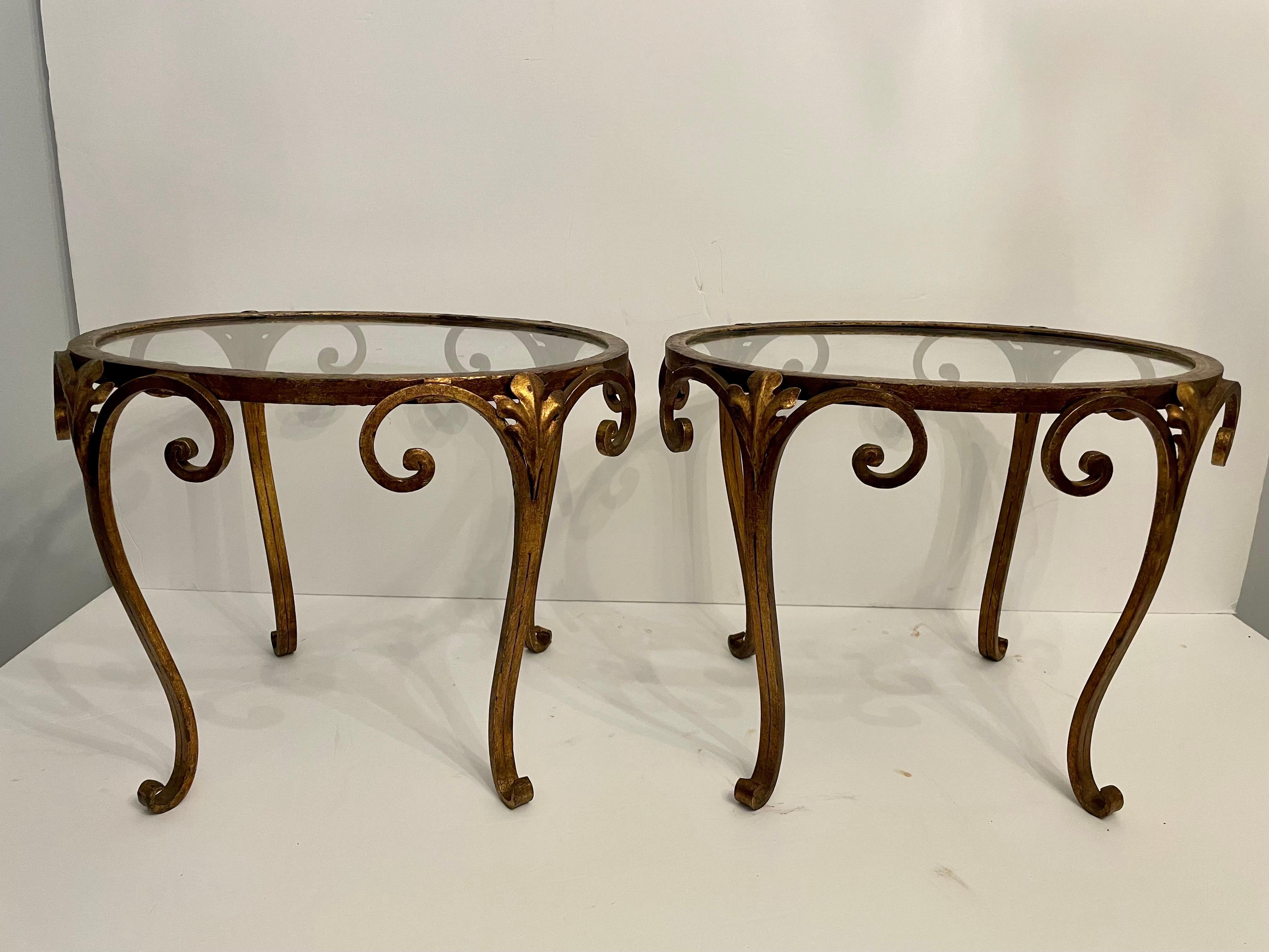 Pair Super Chic French Gilt Wrought Iron And Glass Side Tables. Good overall condition, slight finish loss around top edge, and few scratches to glass due to age and use. Each measures 20
