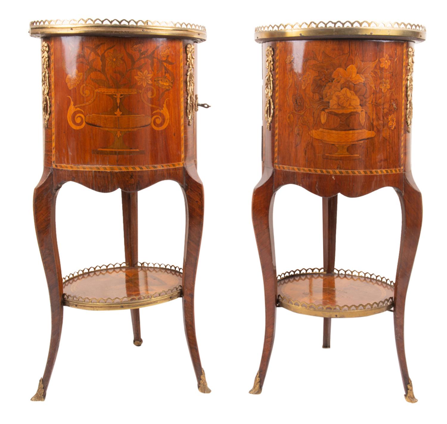 A good quality pair of late 19th century French circular inlaid side cabinets, each with classical oriental influenced inlaid decoration, an ormolu gallery, one with three drawers the other with a cupboard and drawer within., raised on three