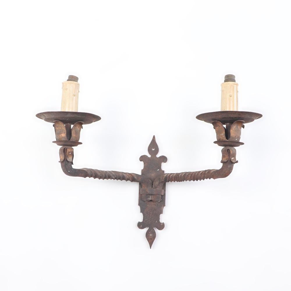 Pair French iron two arm wall sconces with old traces of gold on the leaves circa 1910.