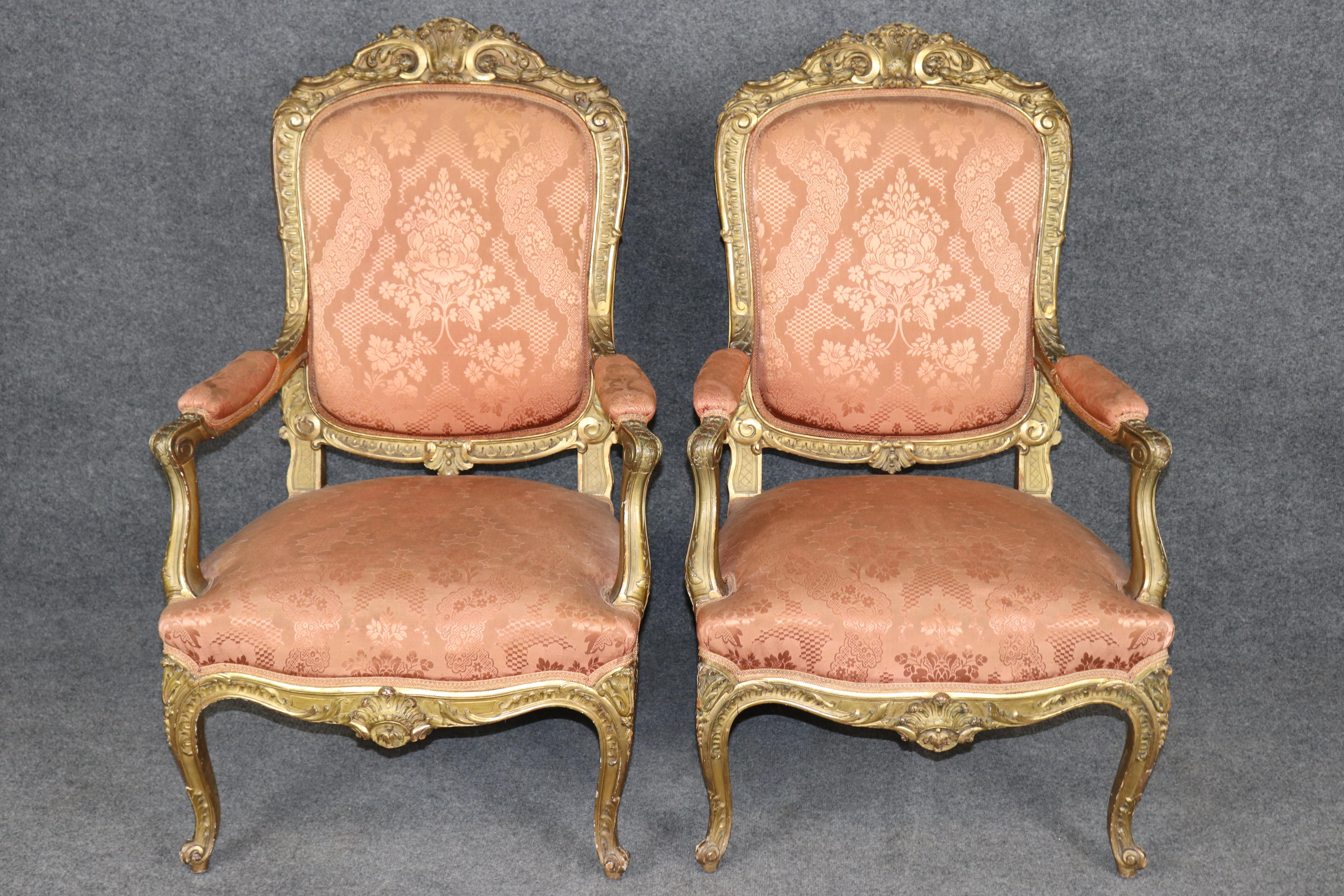 
This outstanding pair of French Louis XV armchairs, dating from the 19th century, represents the epitome of Rococo luxury and craftsmanship. Each fauteuil is richly gilded with hand-carved details, highlighting the exquisite asymmetrical scrolls,