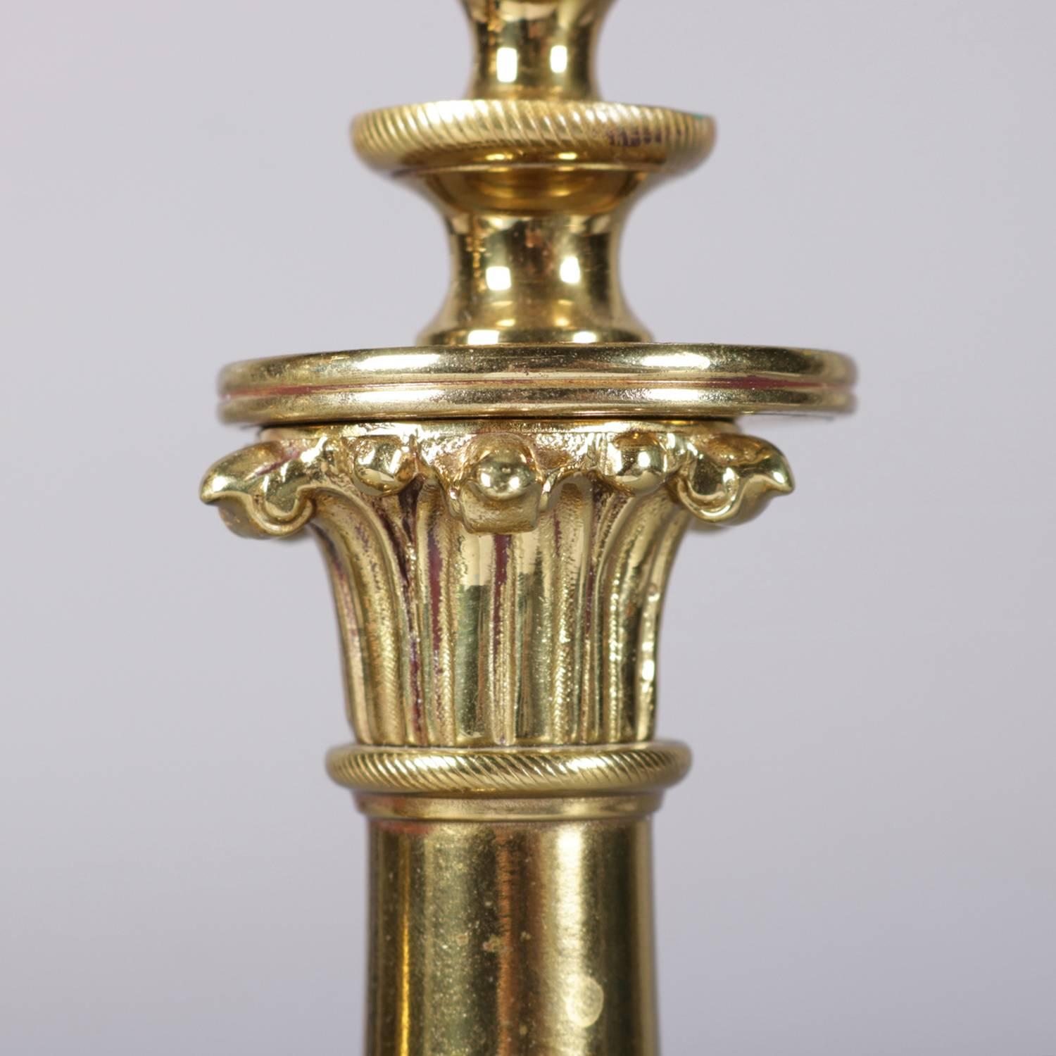 Pair of French Louis XIV style gilt candlesticks feature Corinthian column-form capitals above shaped shaft with beaded lower, supported on tripod scroll and foliate base, 19th century

Measure: 11