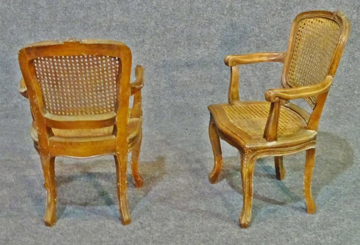 Cane back and seat. Carved wood frames. Measures: 25 3/4