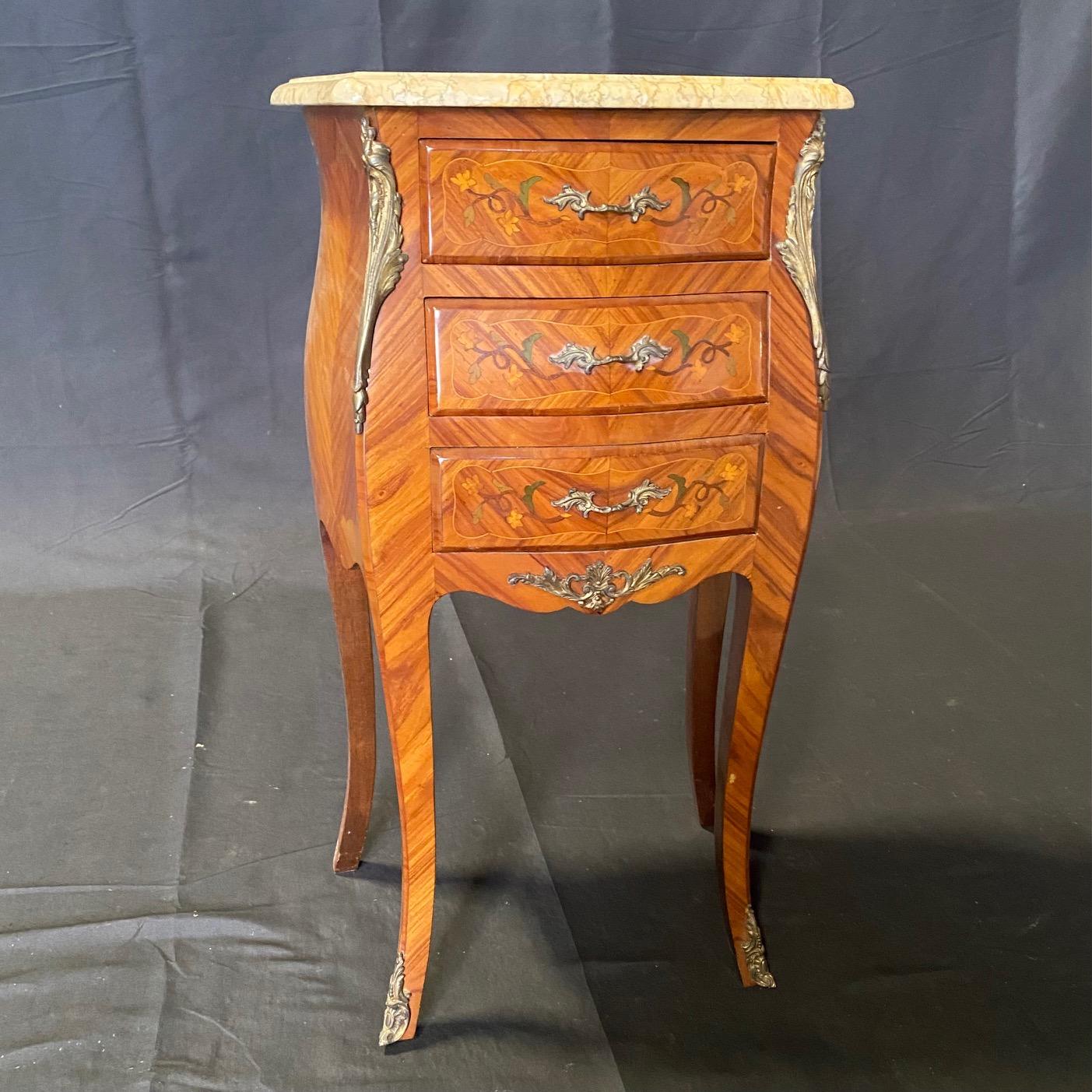 Pair of French Louis XV marble top night stands, 20th century, shaped marble top with molded edge, over case with herringbone inlay, gilt metal mounts, fitted with three shaped drawers, rising on lovely cabriole legs over French bronze bracket feet.