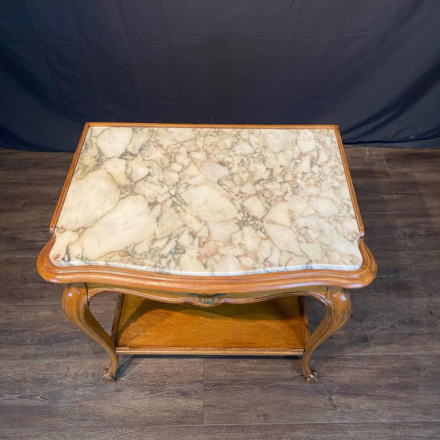 French Louis XV style walnut marble top end tables, side tables or sofa tables; each with a single drawer and lower shelf: a timeless reminder of what many consider a definitive French style. Gracefully shaped table top with a recessed and inset